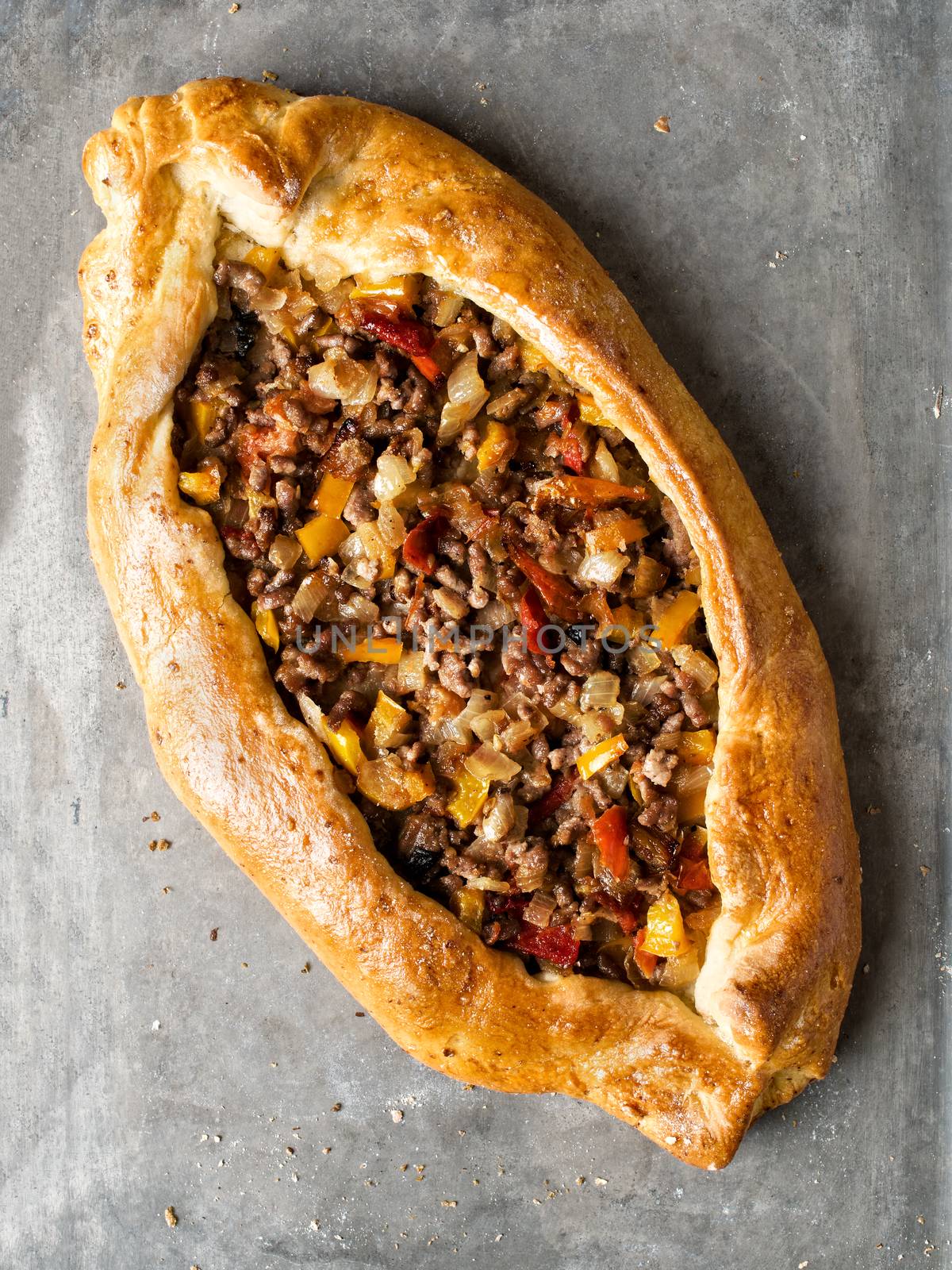 close up of rustic golden turkish pide bread pizza