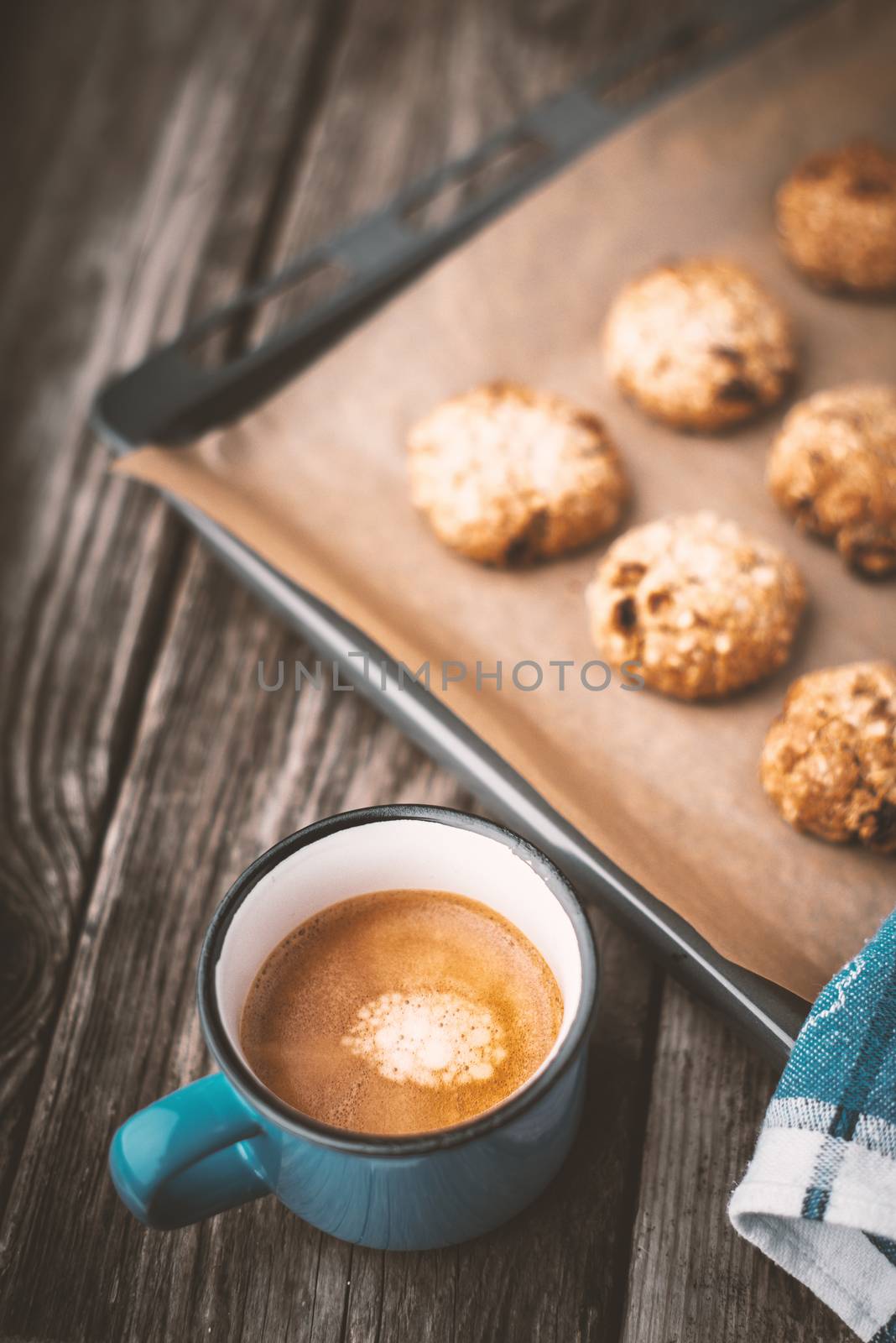 Oatmeal cookies and coffee cup on a wooden table vertical