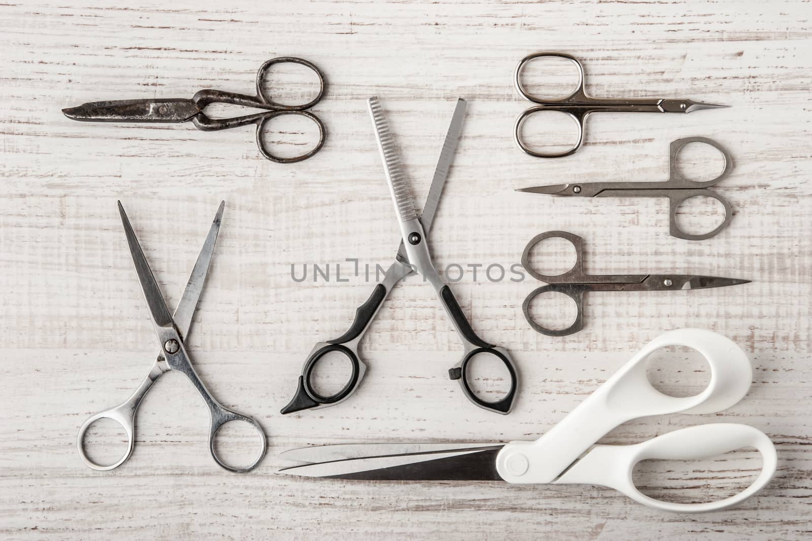 Set of scissors on a wooden table horizontal, super style live