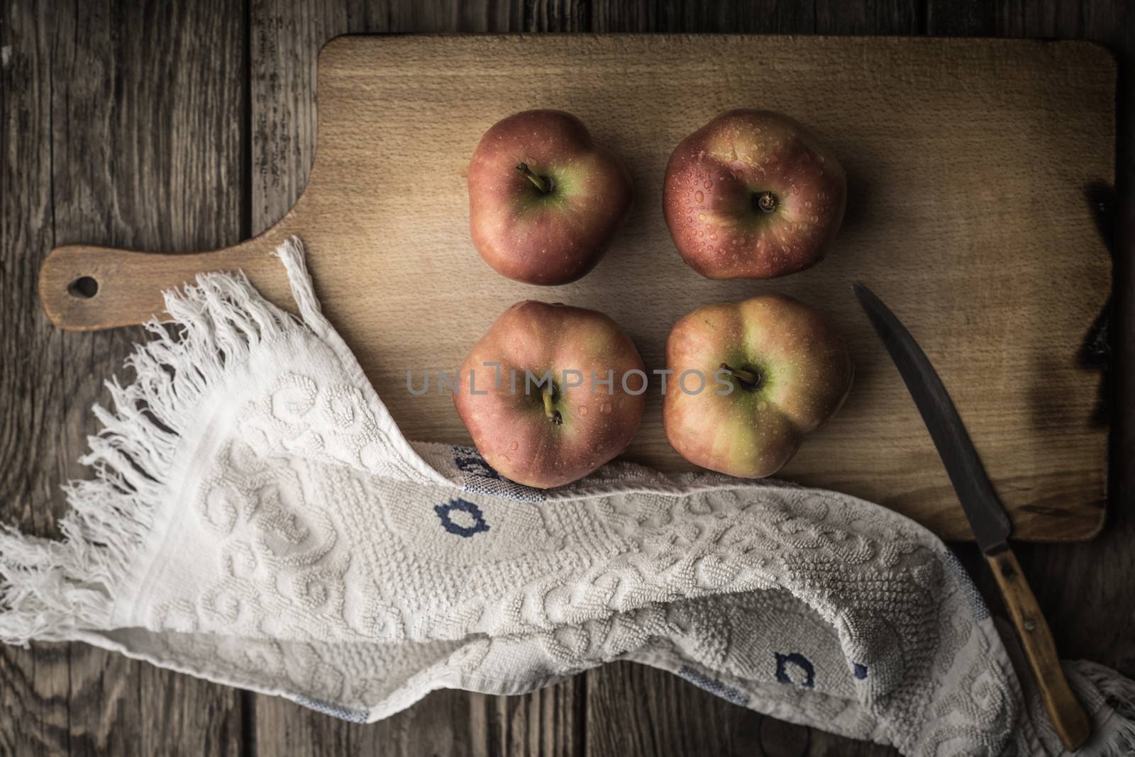 Red apples and towel on the cutting board horizontal