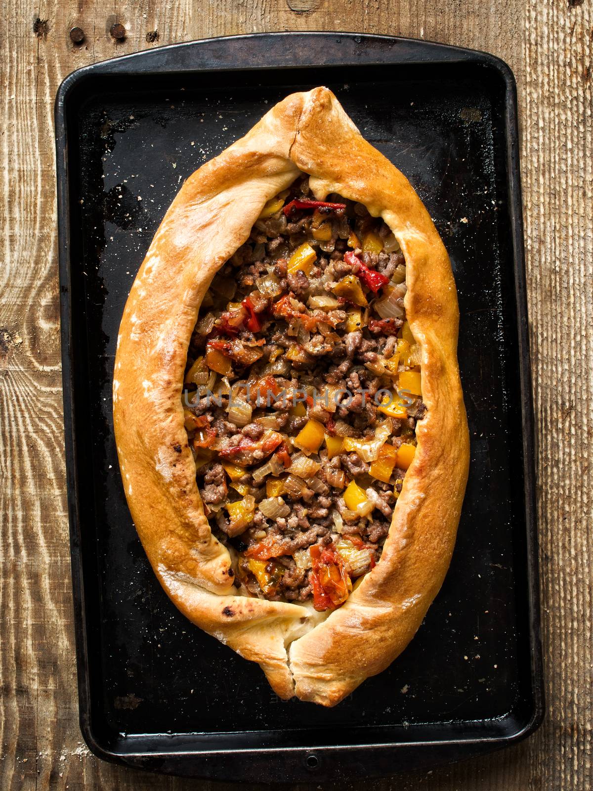 close up of rustic golden turkish pide bread pizza