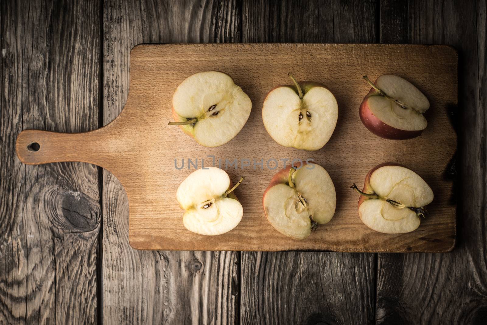 Apple halves on a cutting board horizontal