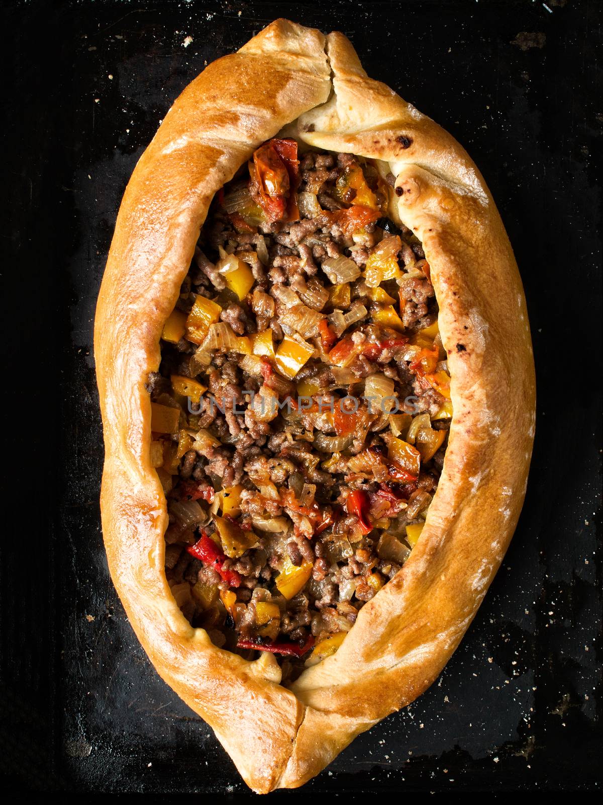 close up of rustic golden turkish pide bread pizza