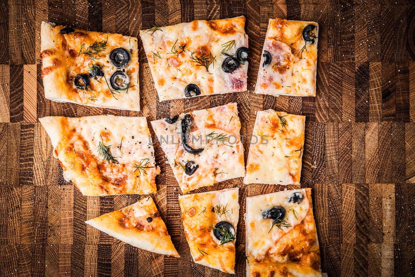 Slices of pizza on a wooden board horizontal