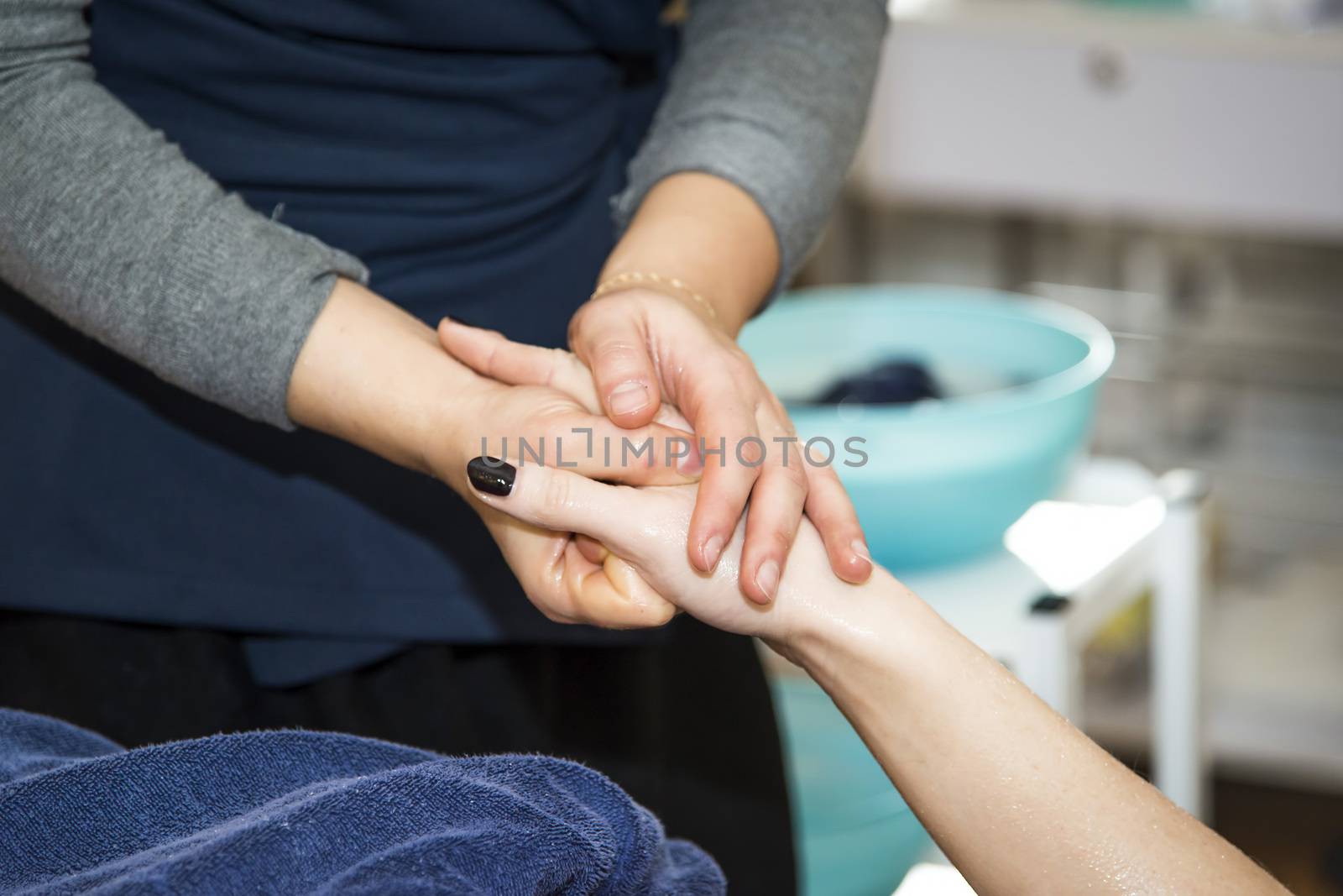 Massaging of young woman in SPA