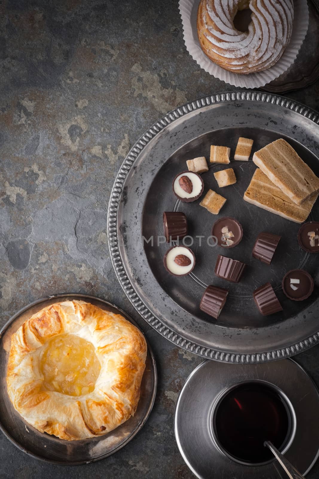 Candy, cake and coffee on a gray stone by Deniskarpenkov