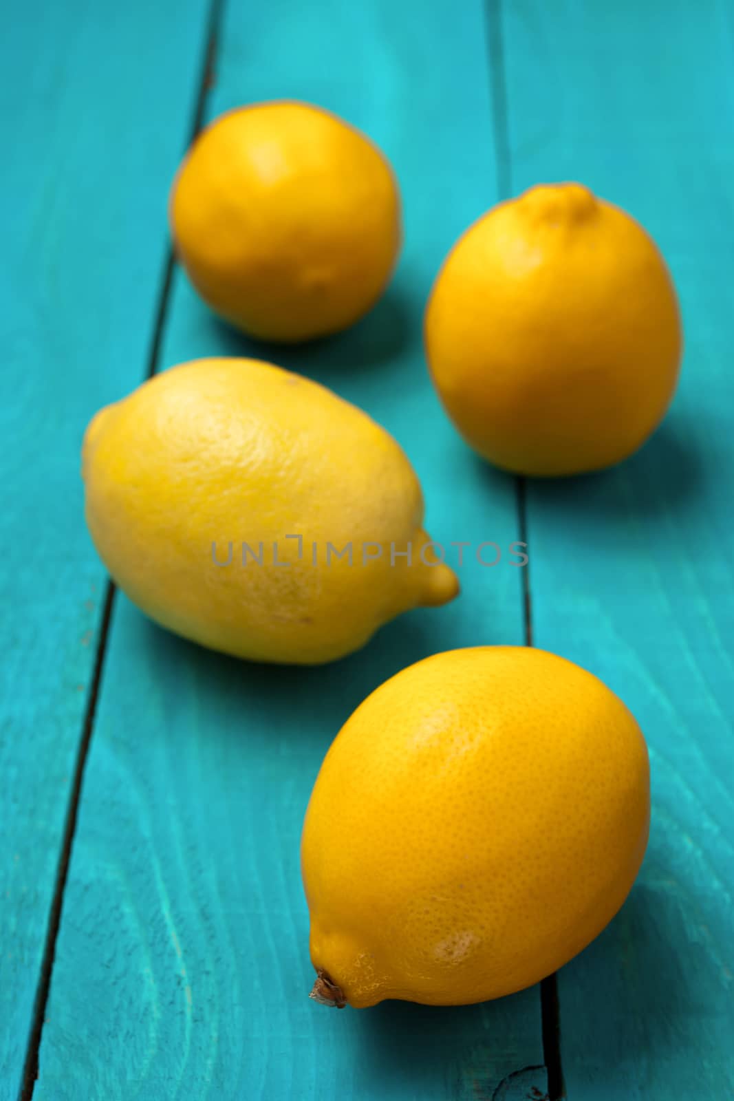 Lemons on the bright cyan background by Deniskarpenkov