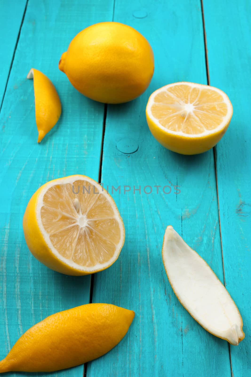 Lemons on the bright cyan background by Deniskarpenkov