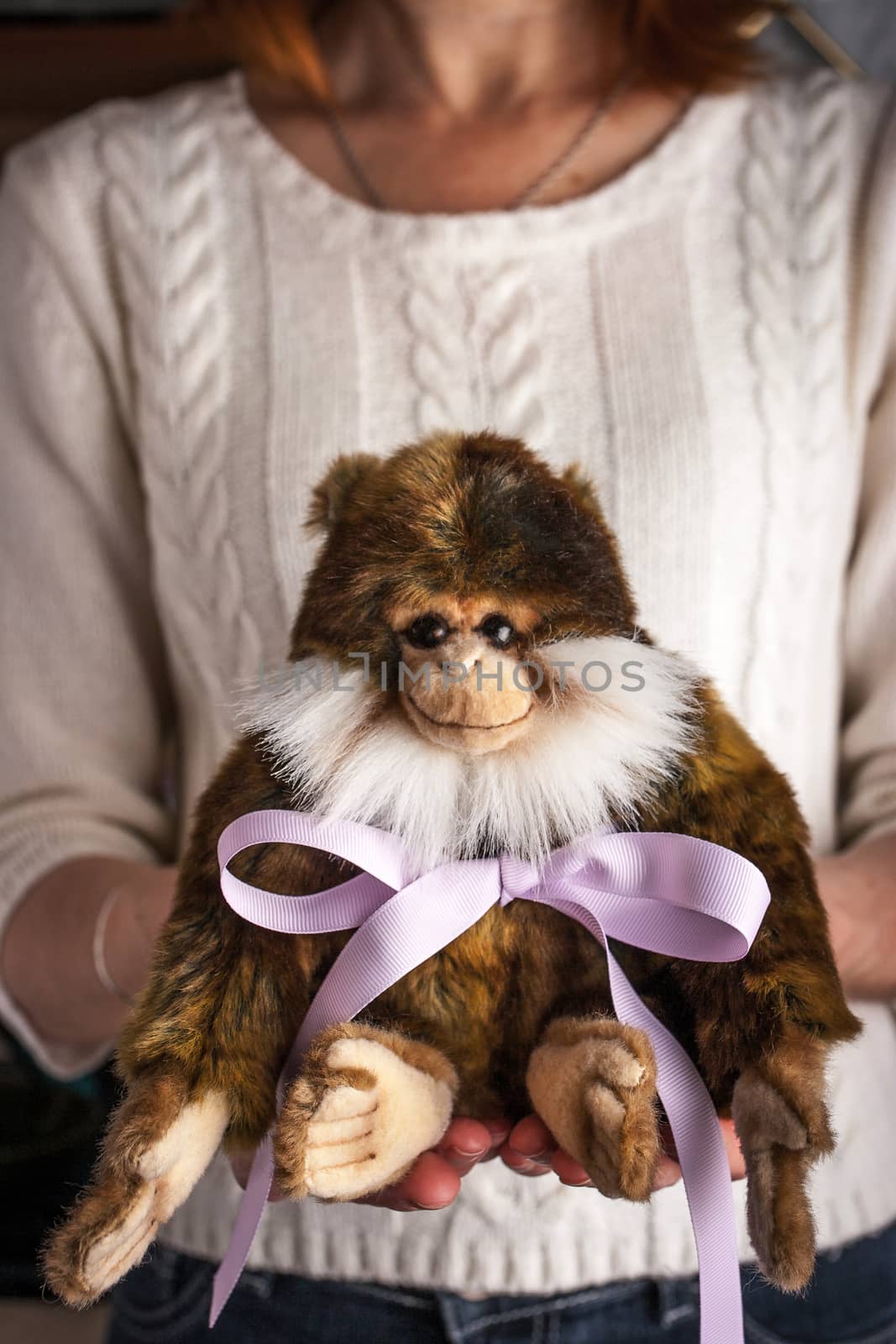 Monkey toy  with violet ribbon in the hands vertical