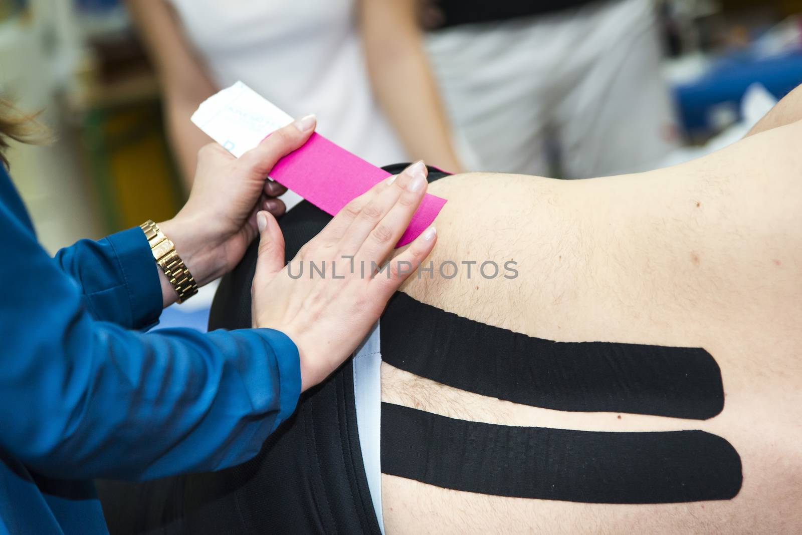 Massaging of young woman - kinesiotaping by furzyk73
