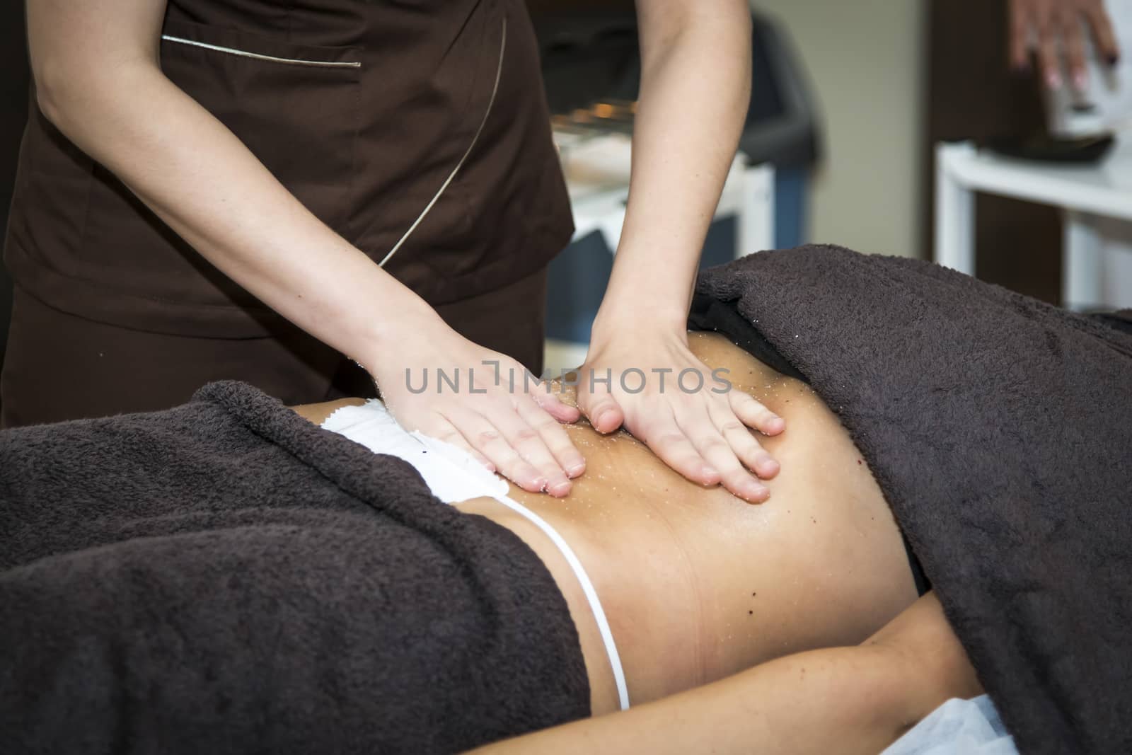 Massaging of young woman in SPA