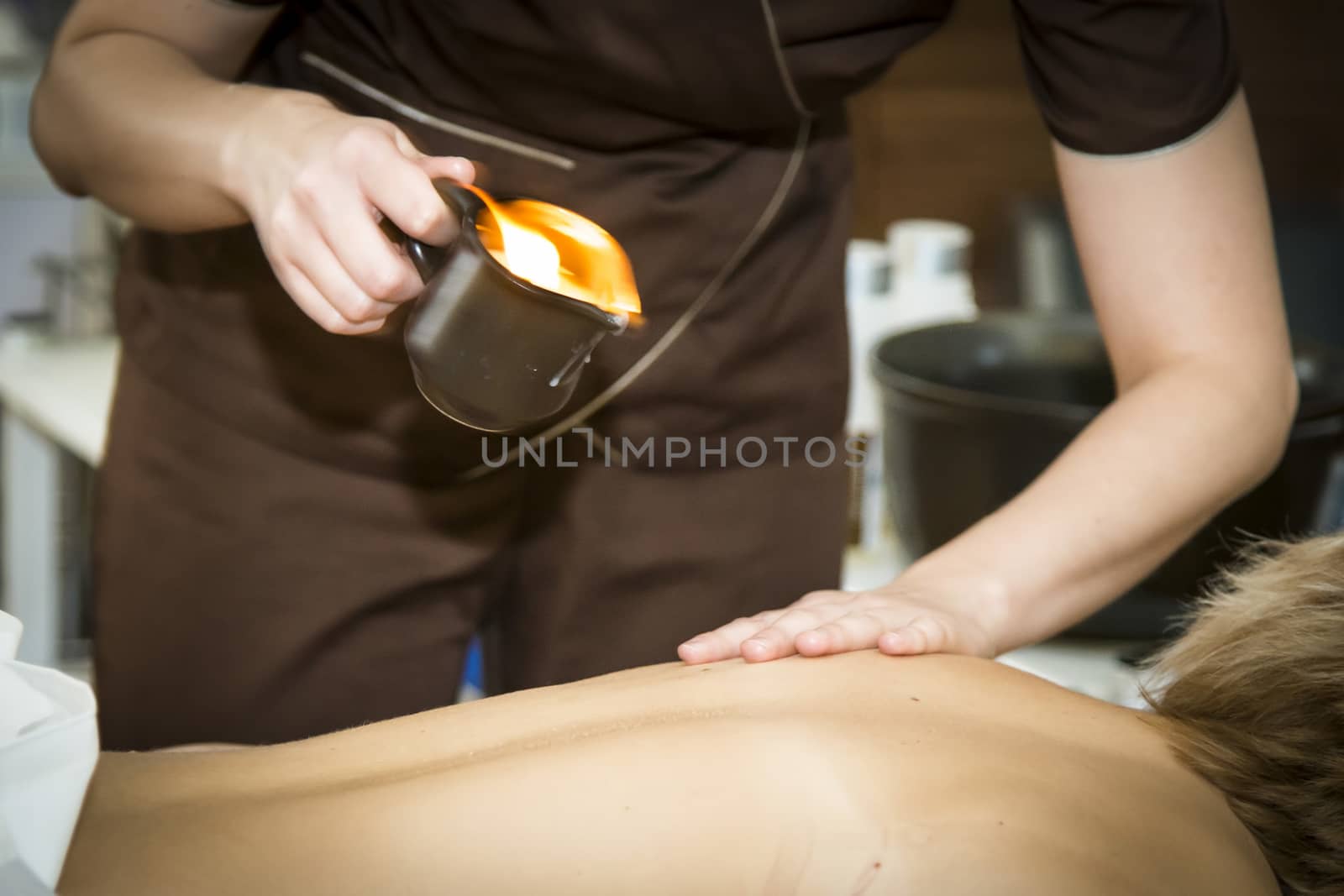 Massaging of young woman in SPA