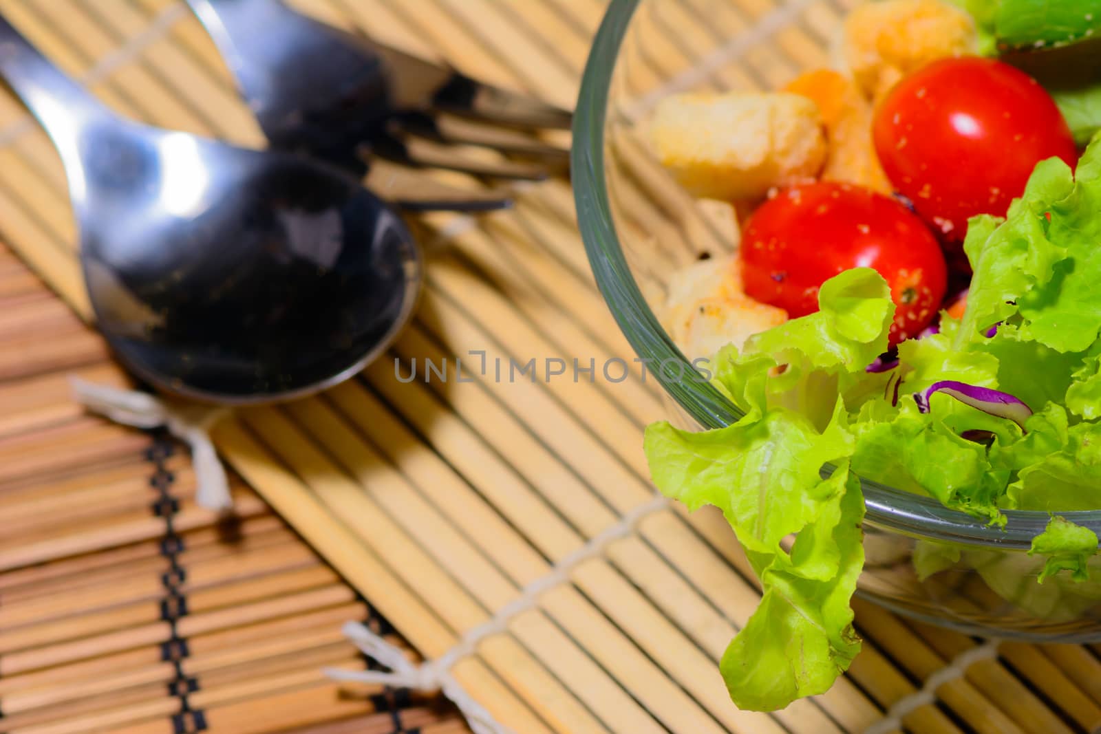 Fresh green salad with spoon and for