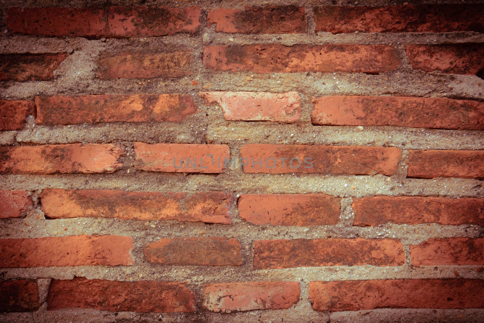 Weathered texture of stained old dark brown and red brick wall background