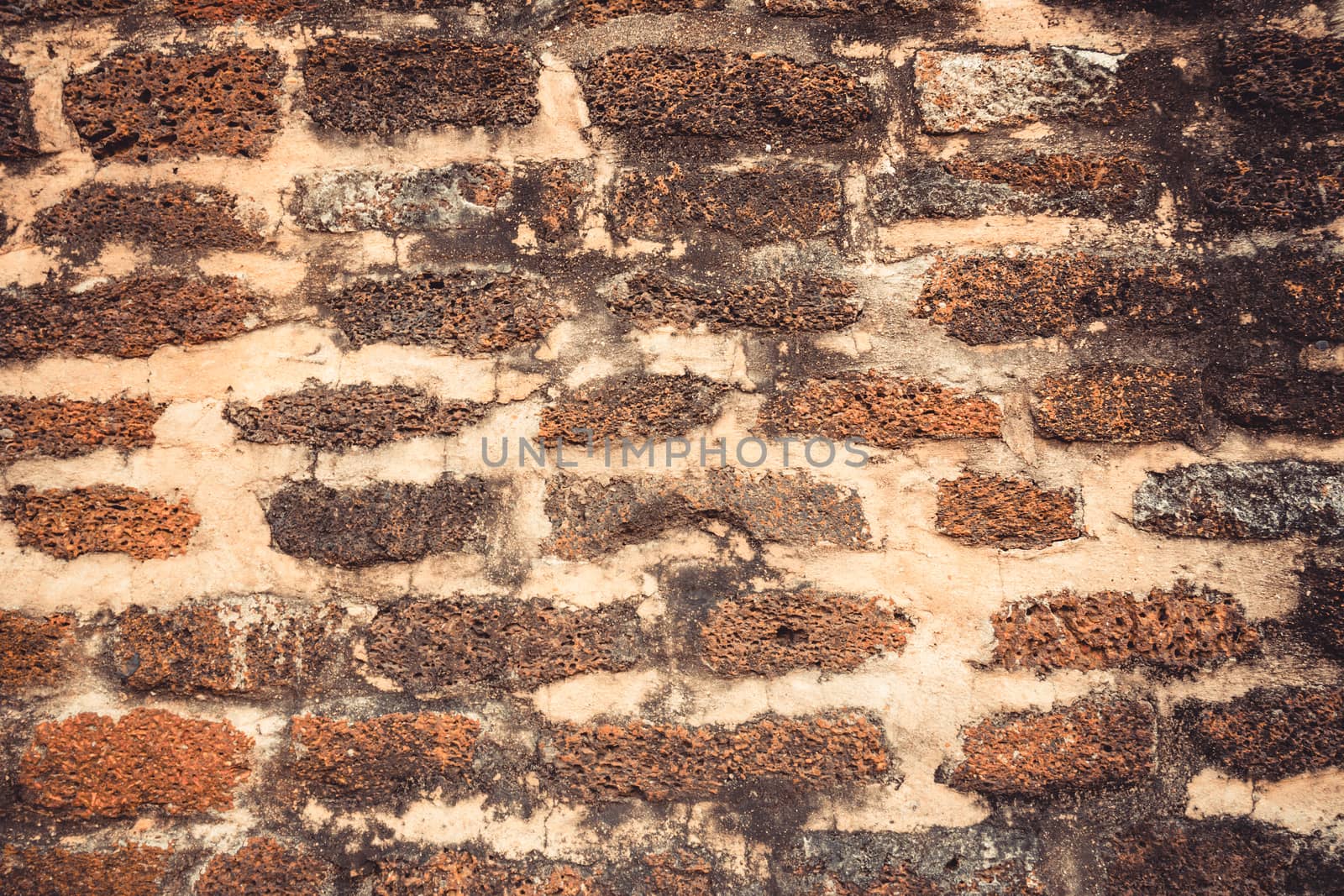 Weathered texture of stained old dark brown and red brick wall background