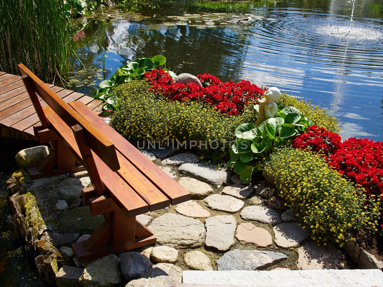 Beautiful classical design landscaped lush green blooming garden fish pond with water lily