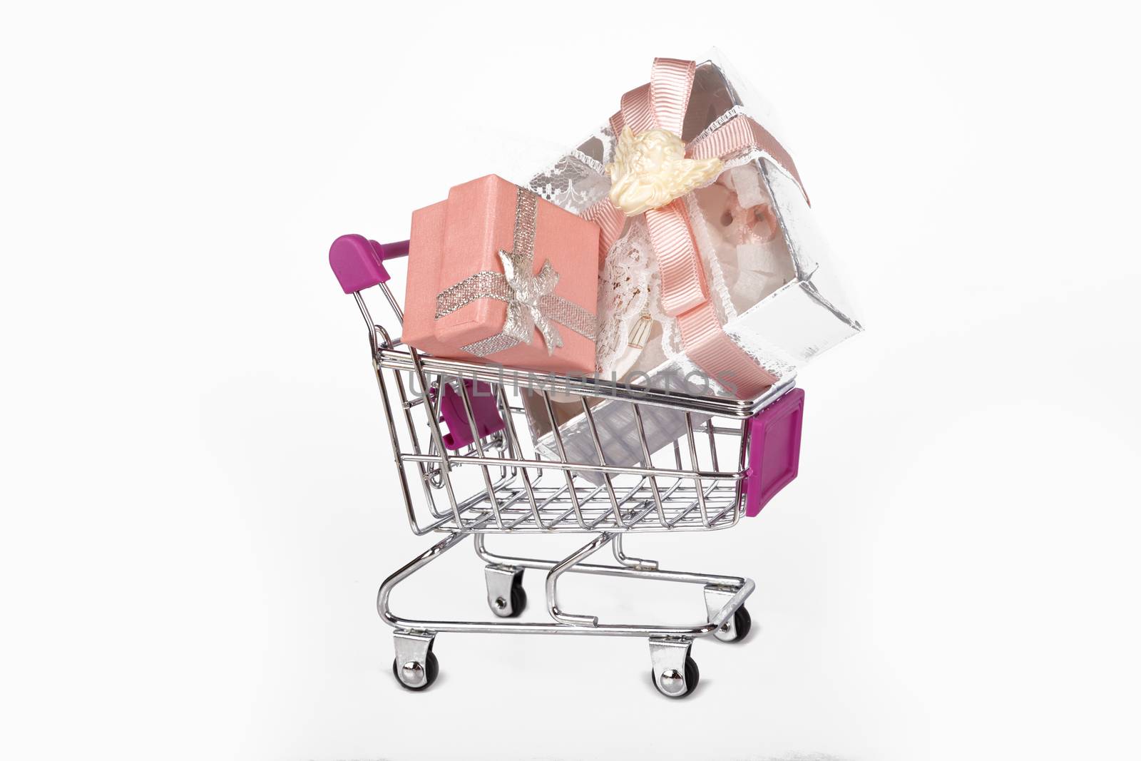 Side view of shopping card or trolley with colorful gift boxes isolated on white background.