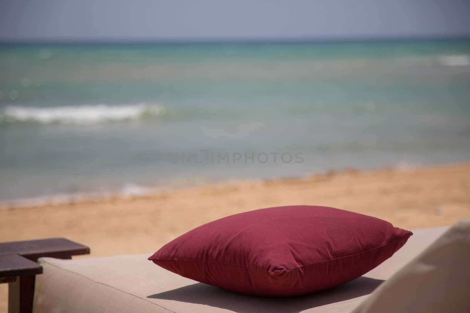 Pillow at the beach with ocean in background