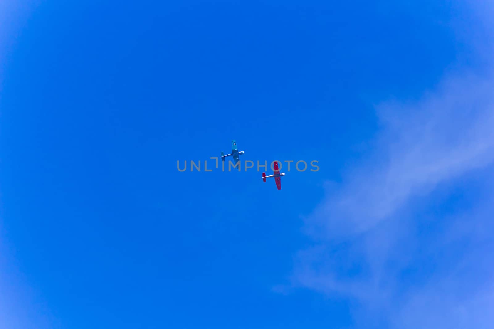 Photo of two flying military airplanes in blue sky