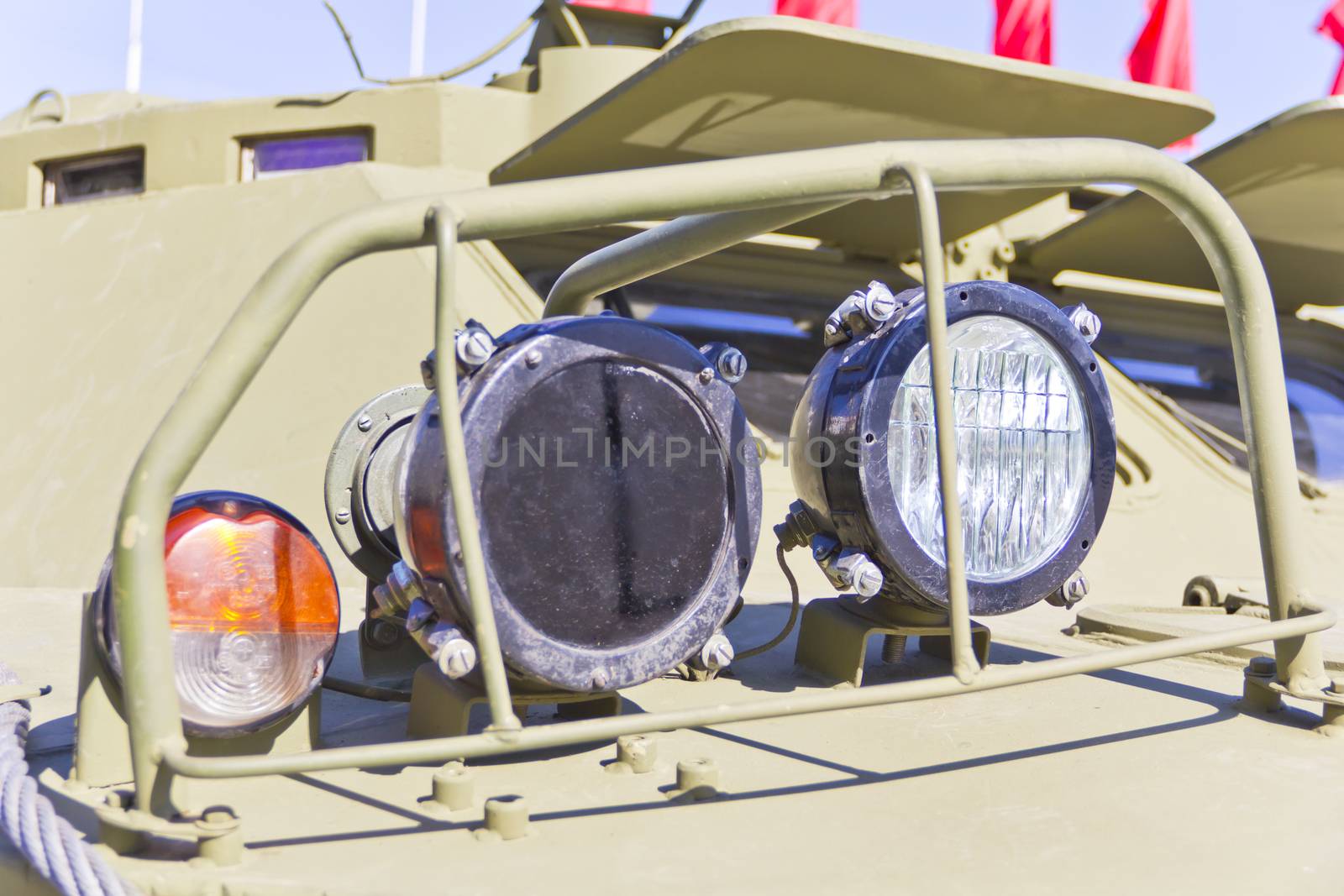 Headlight of military machine at the exhibition under open sky