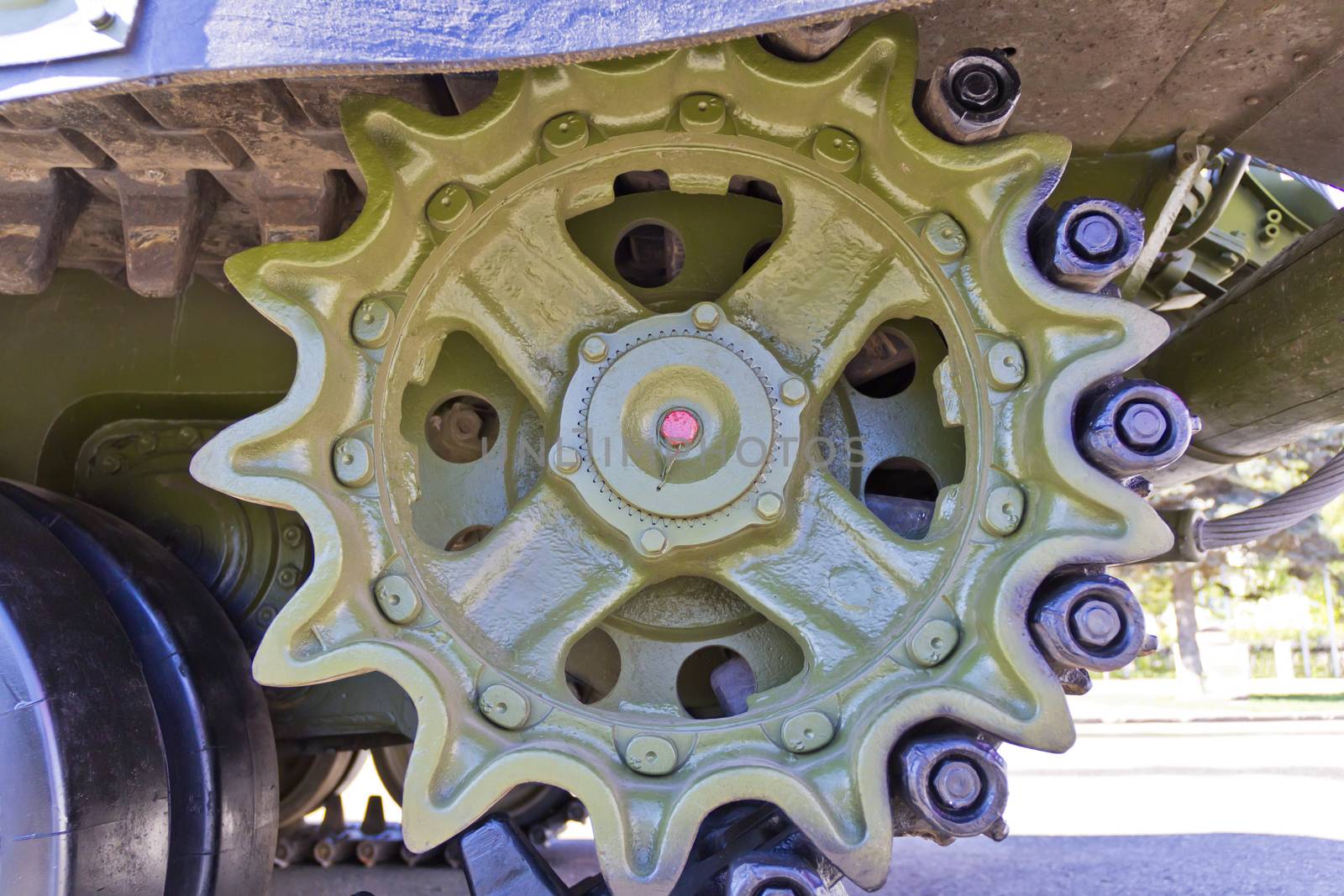 Caterpillar wheel of military machine at the exhibition under open sky