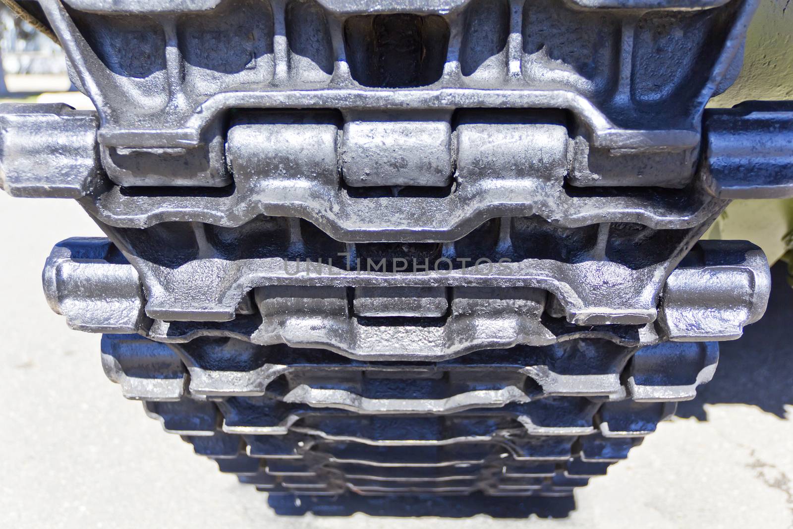 Caterpillar wheel of military machine at the exhibition under open sky