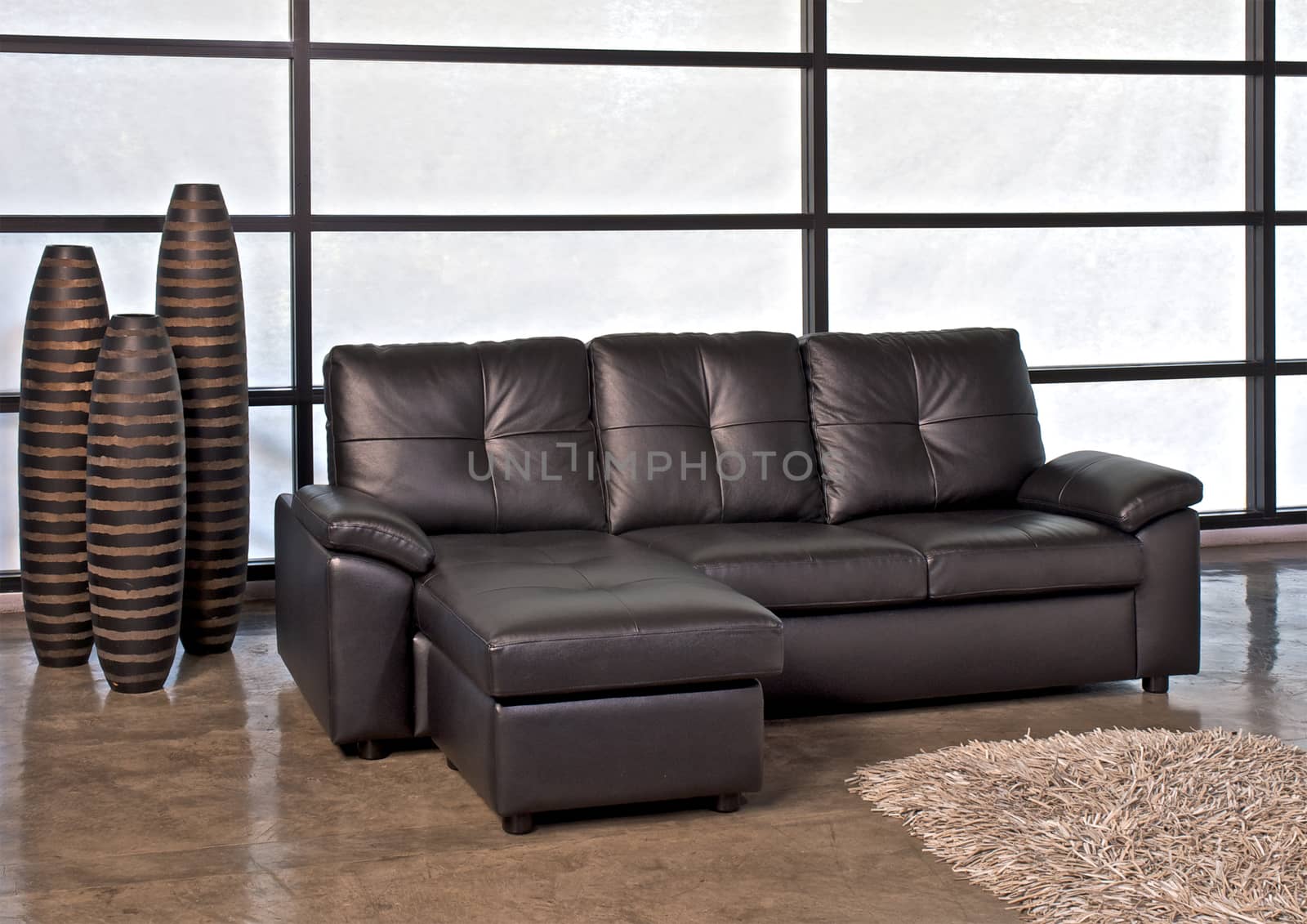 Brown leather sofa with stool for home or office