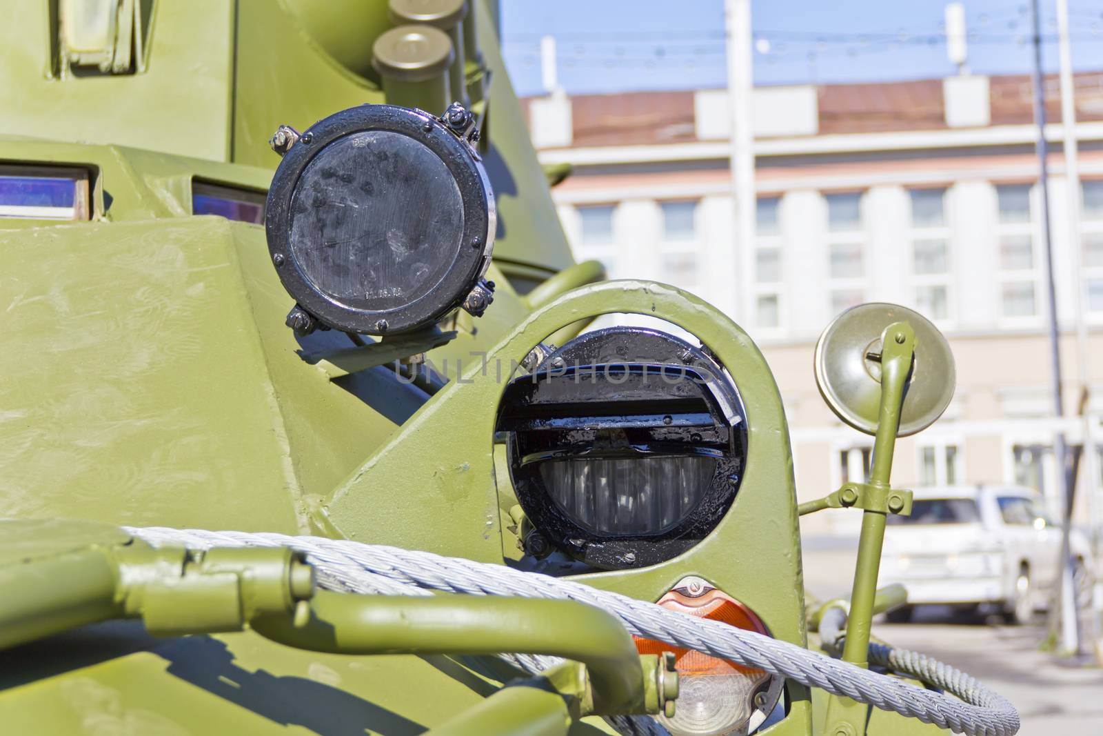 Headlight of military machine at the exhibition under open sky