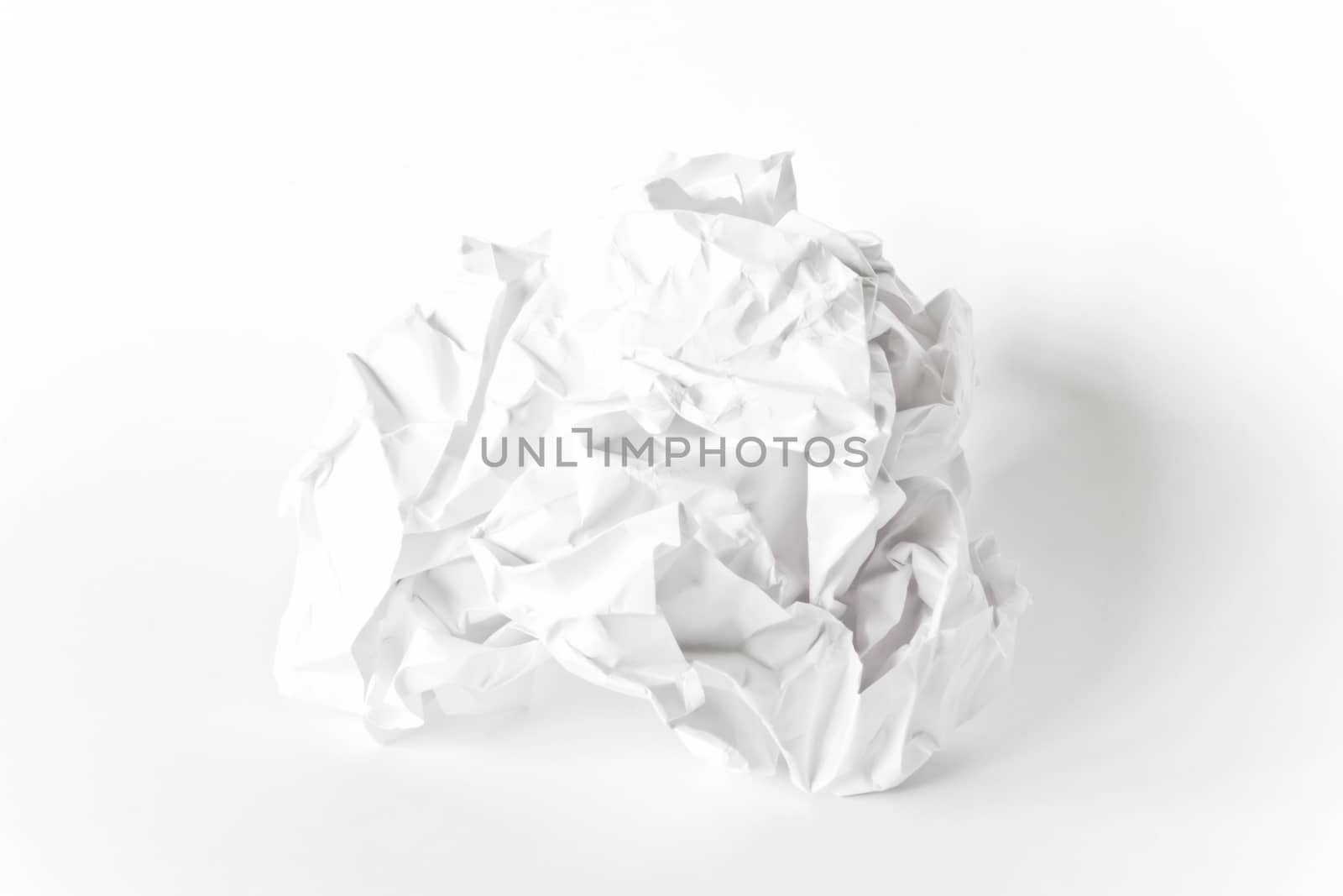 Photo of crumpled paper ball on white background