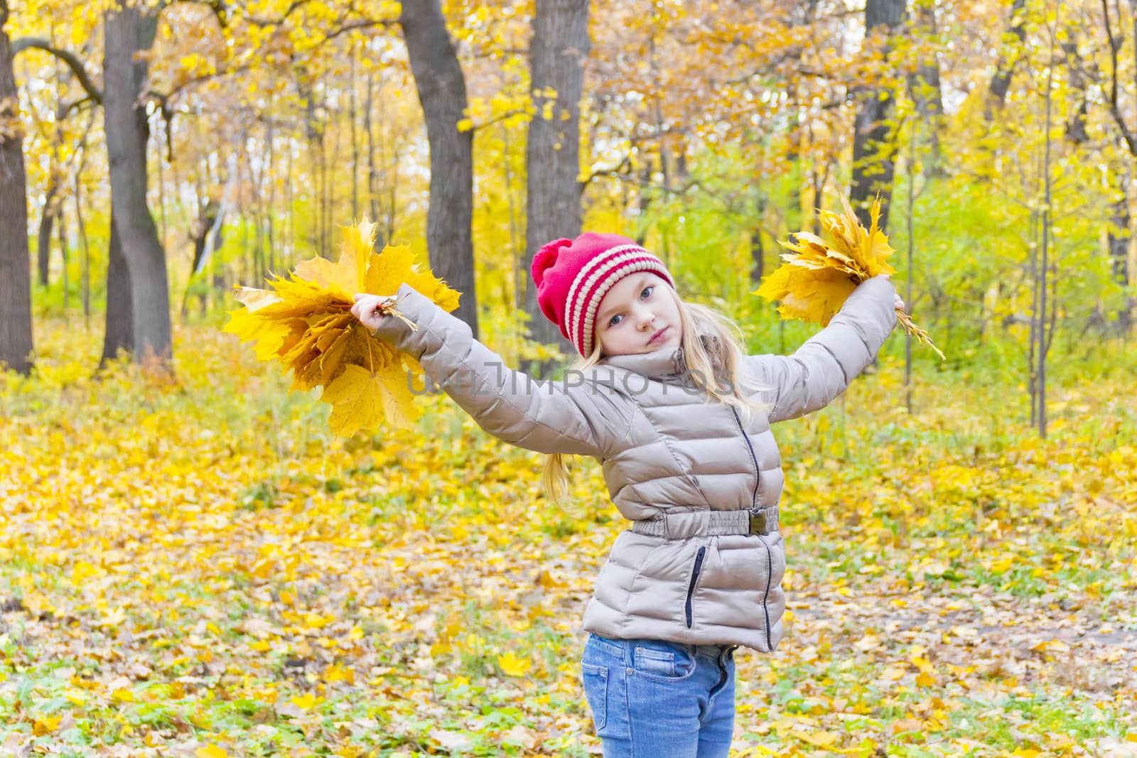Playing girl with two bouquets from sheets in park
