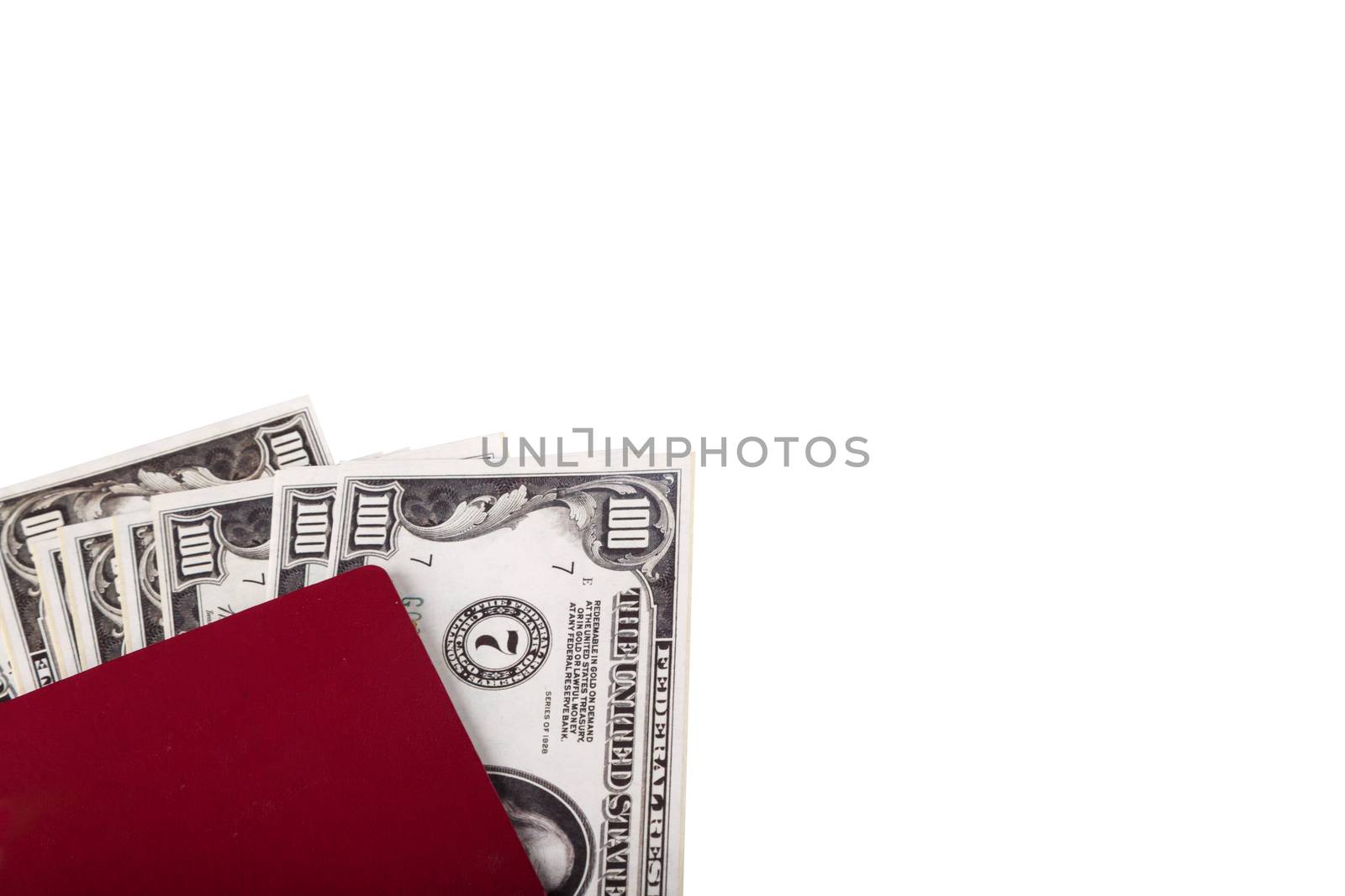 Finance concept, stack of hundred dollar money banknotes in passport or notebook, isolated on white background.