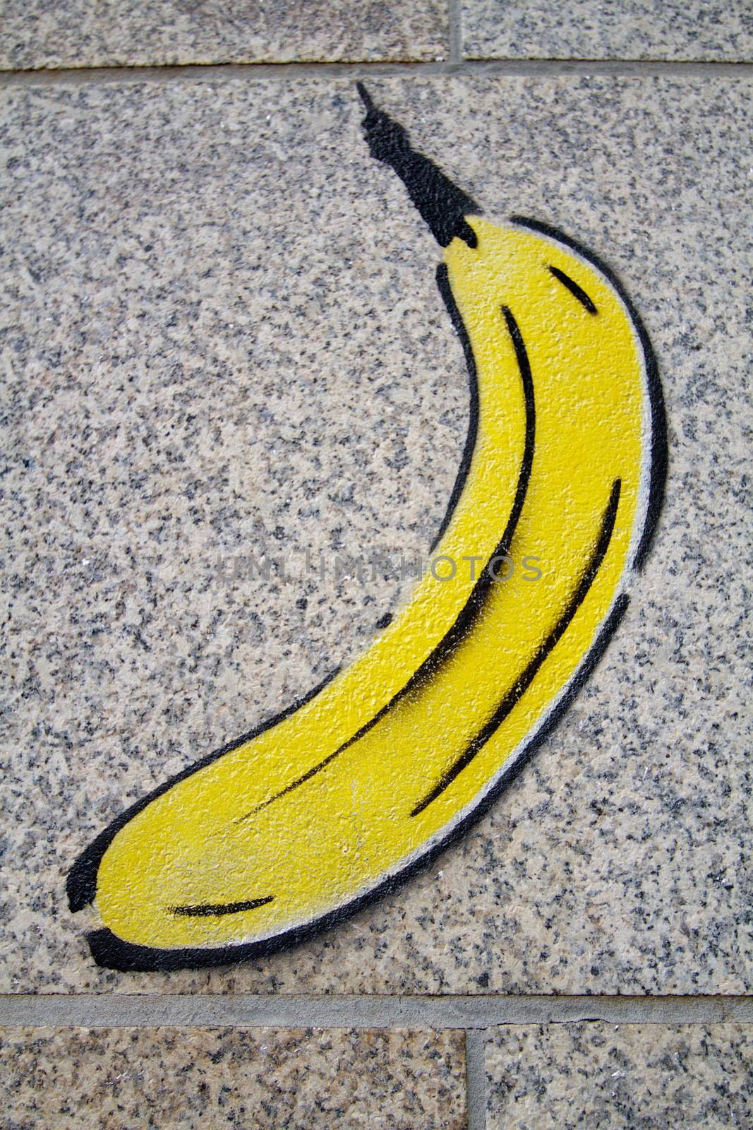 banana yellow graffiti on a wall grey