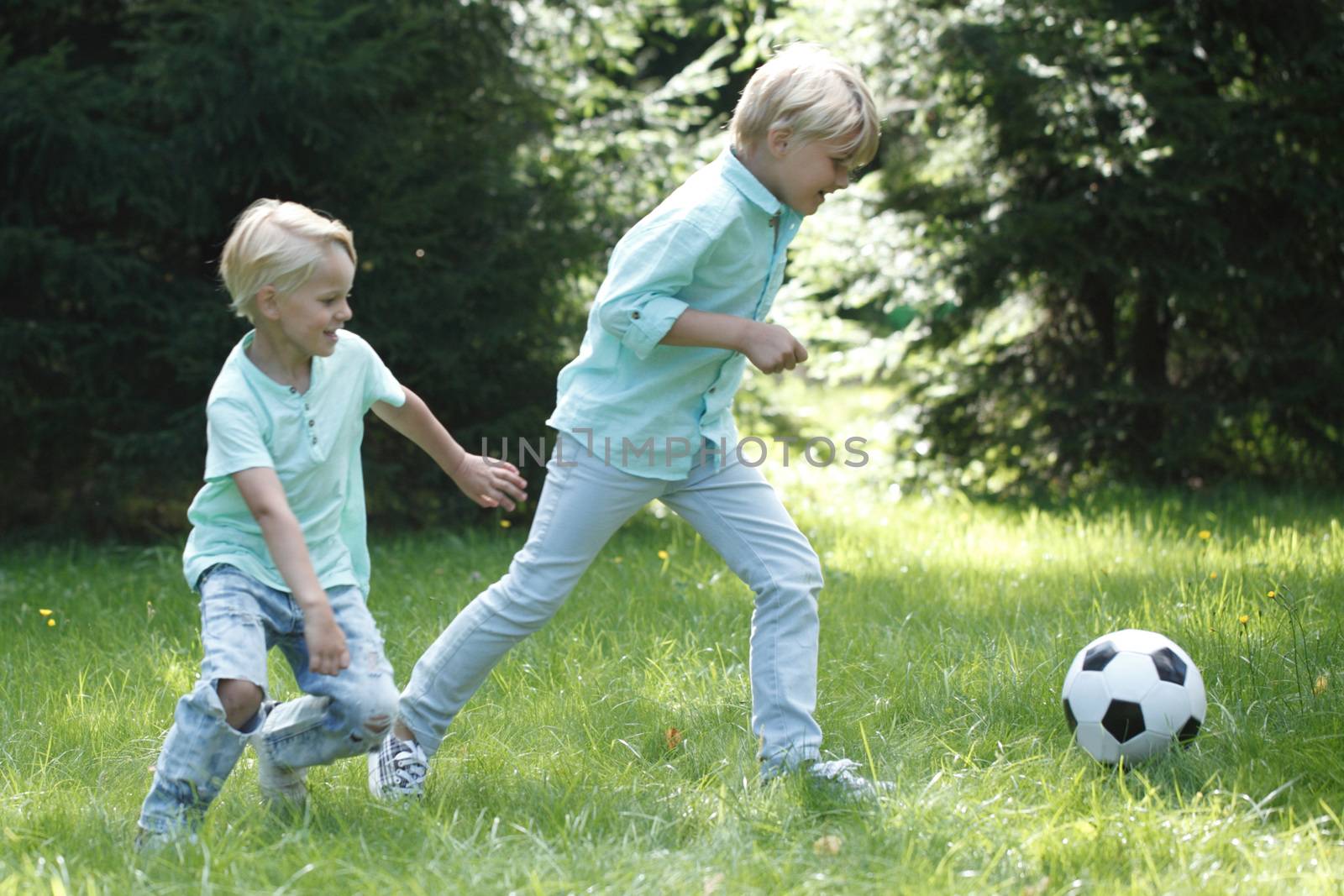 Children playing football by ALotOfPeople