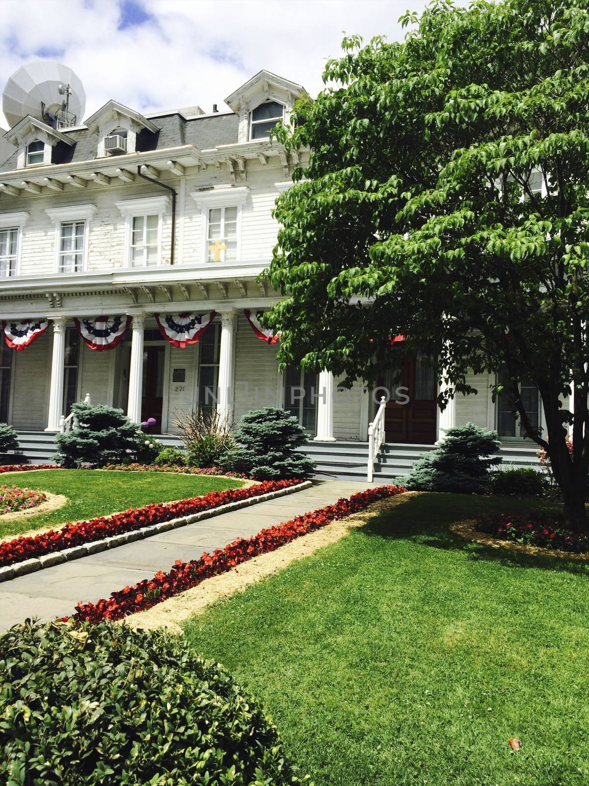 House with American flags and designer garden