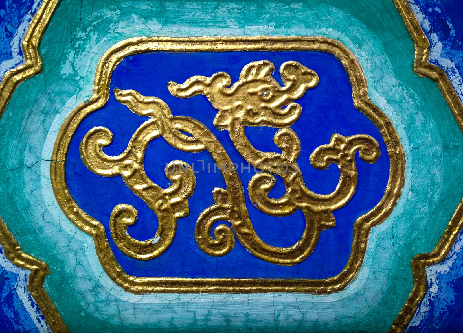 Abstract golden dragon on a ceiling in a temple.