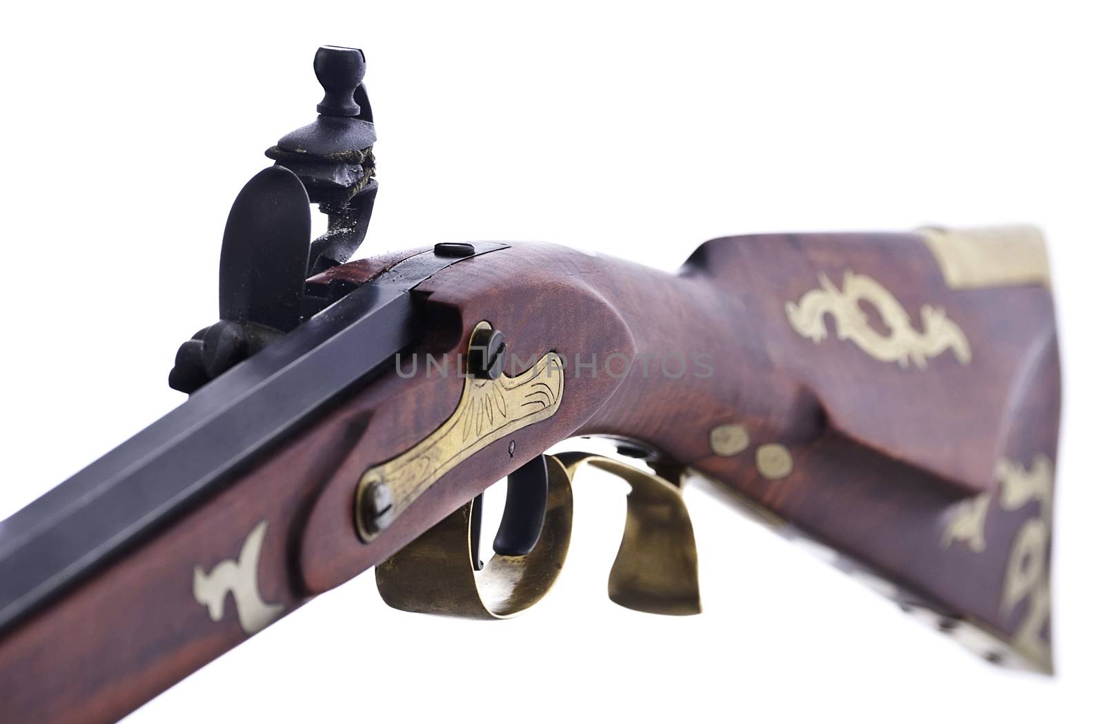 Replica flint lock rifle, close up fiew shoing the inlayed brass and engravings.