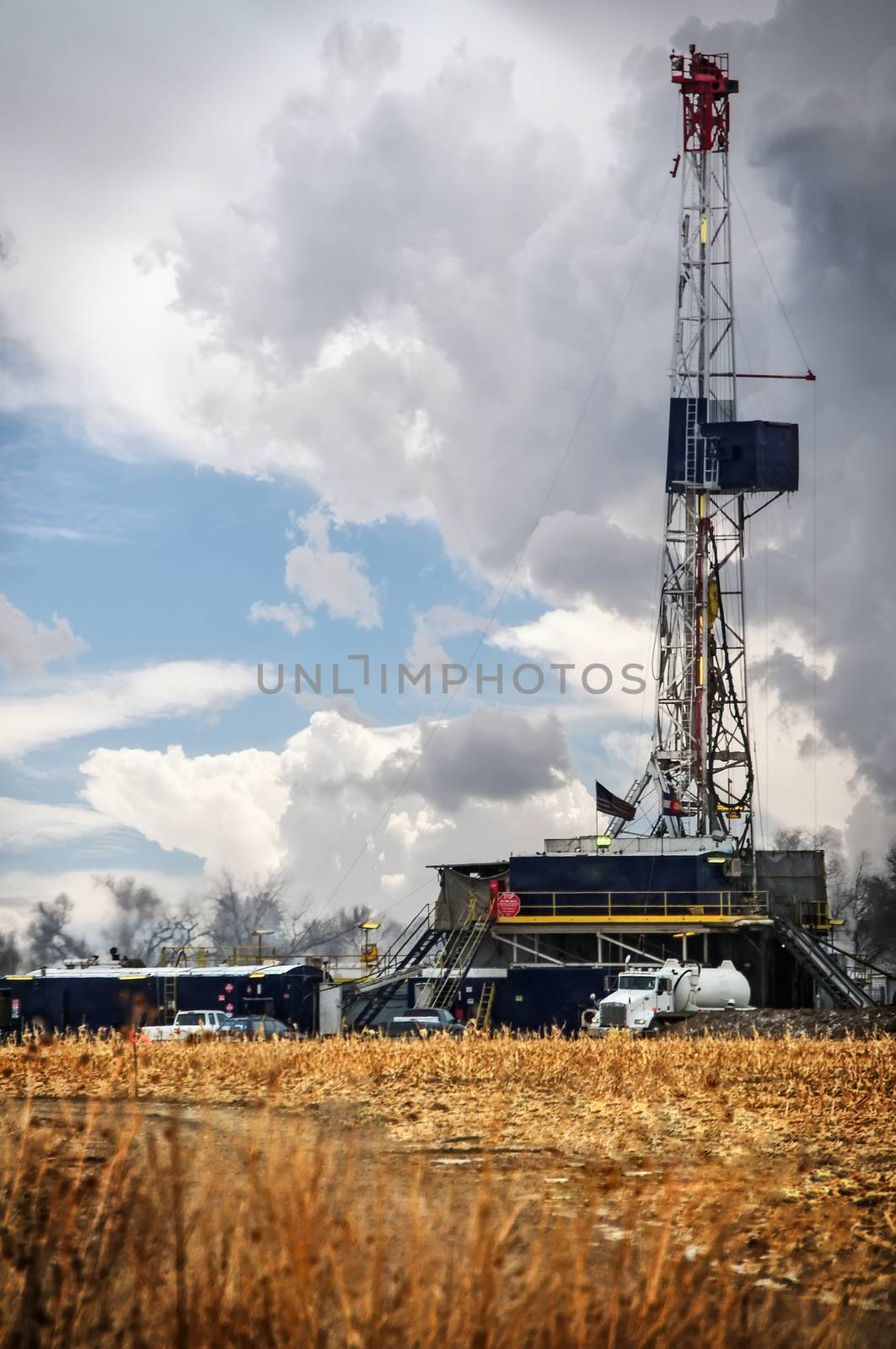 Oil rig in north central Colorado, USA, drilling a gas well under a stormy sky.