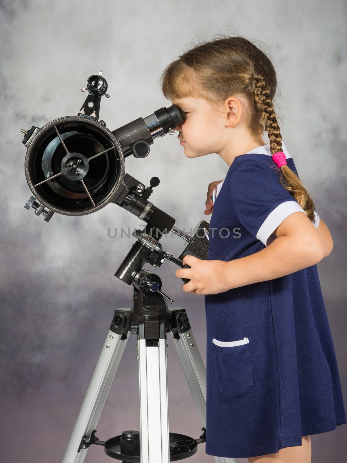 Girl amateur astronomers looking into the telescope eyepiece