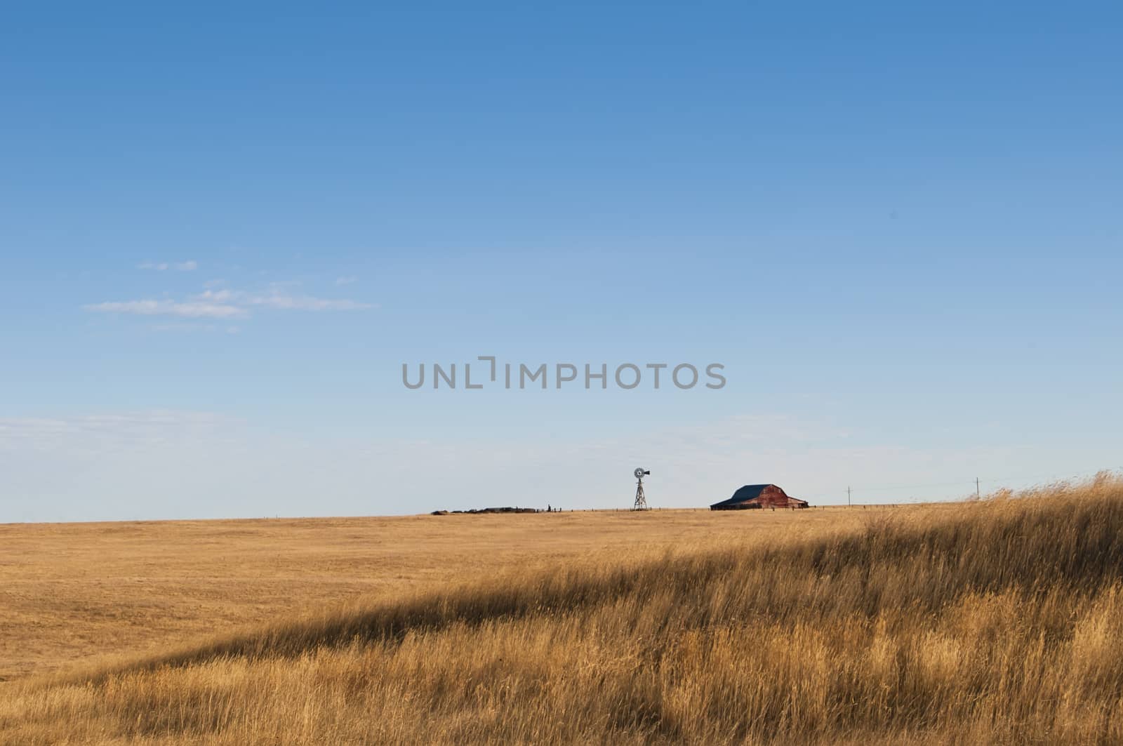 Barn and windmill on the highplains of Wyoming, in the USA