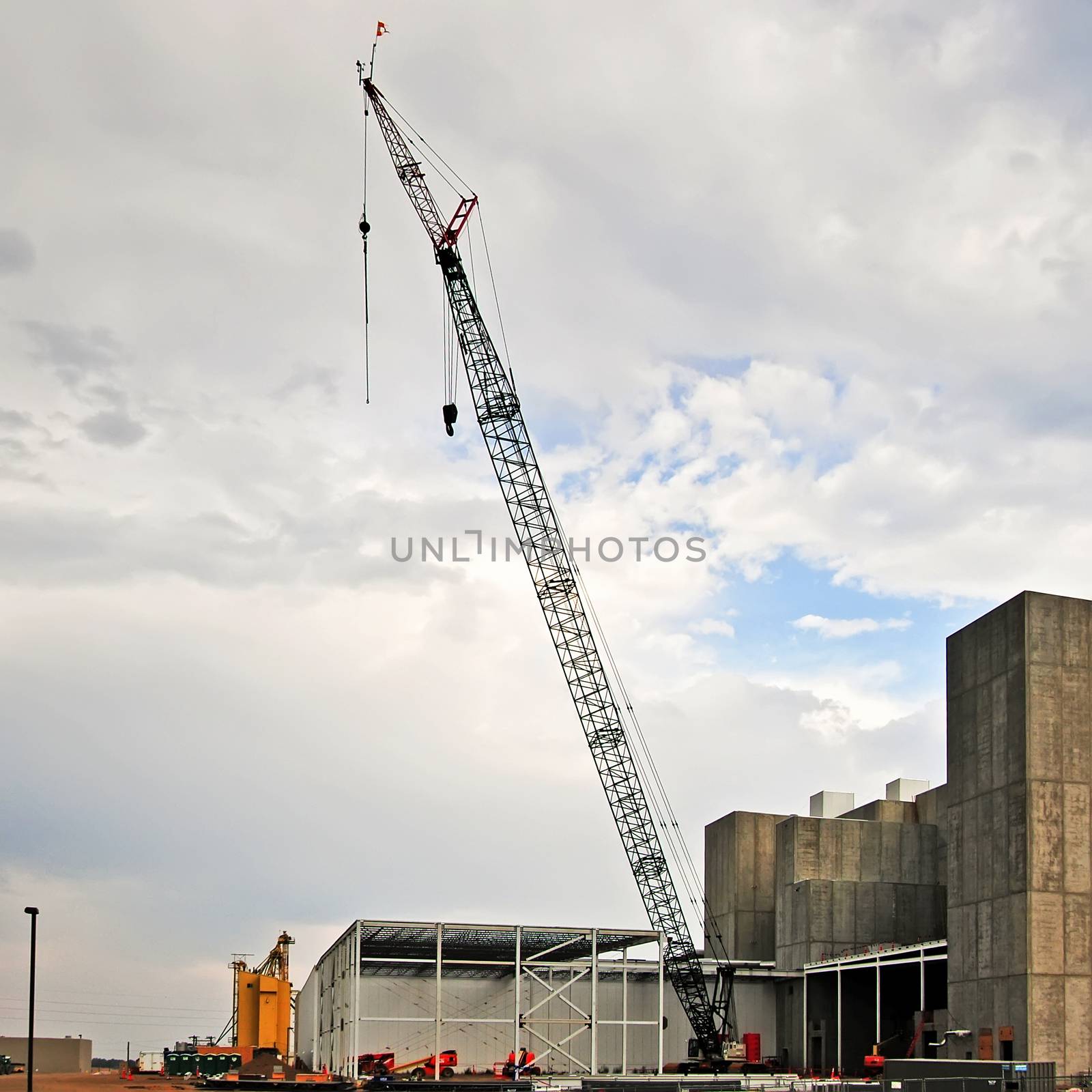Large crane at a construction site. A new facility build in a suburban community creating new jobs.