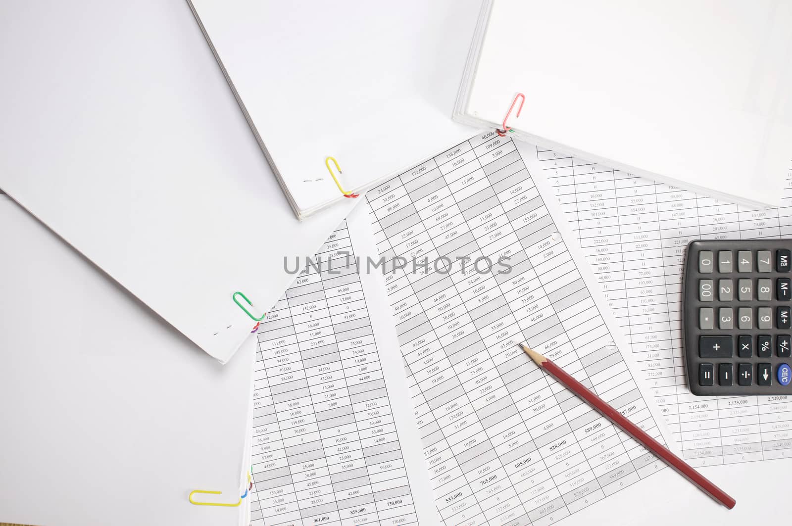 Brown pencil with calculator and stack paperwork of finance account place on wood background.