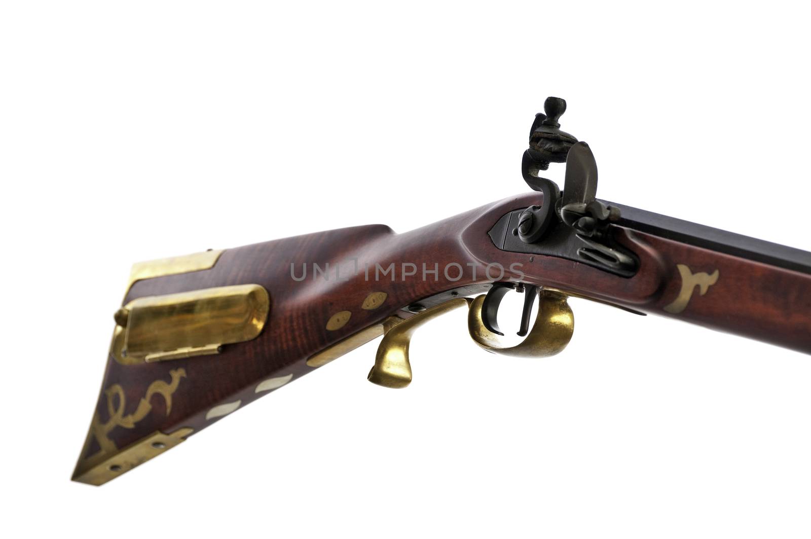 close up view of black powder rifle showing the brass inlays and patch box on the stock.