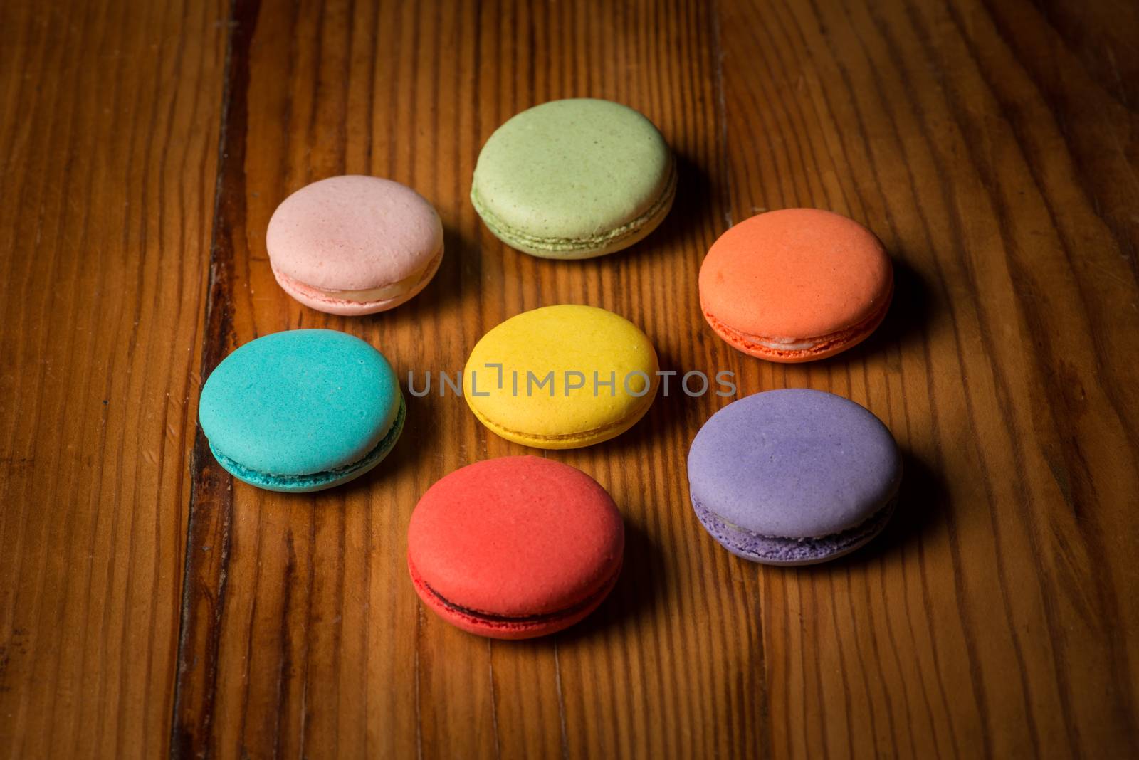 A assorted variety of colorful macaroons on wood