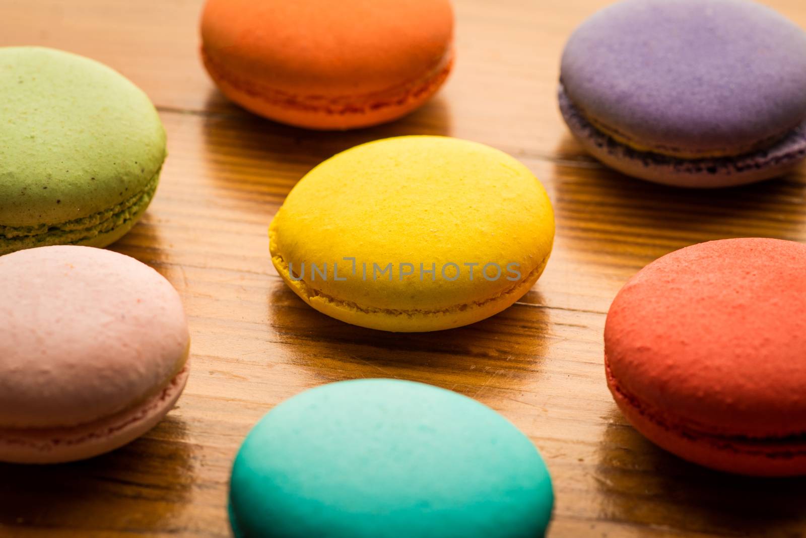 Close-up image of colorful macaroons on wood