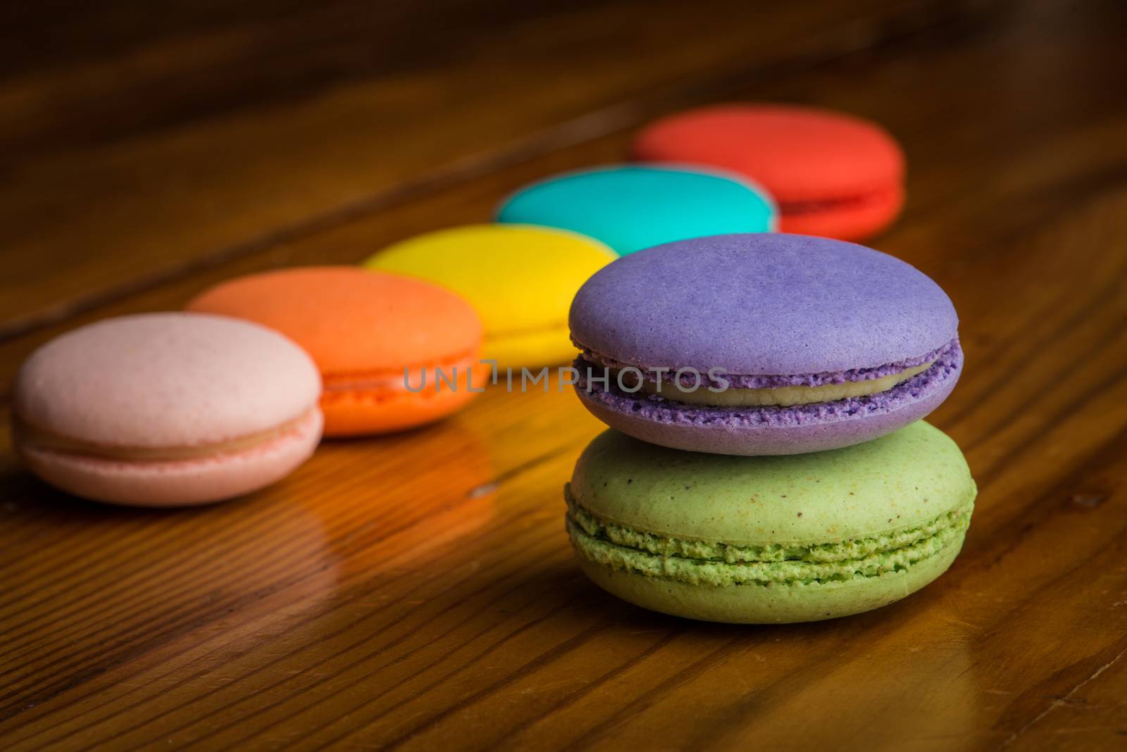Colorful macaroons on a wooden table by gregory21
