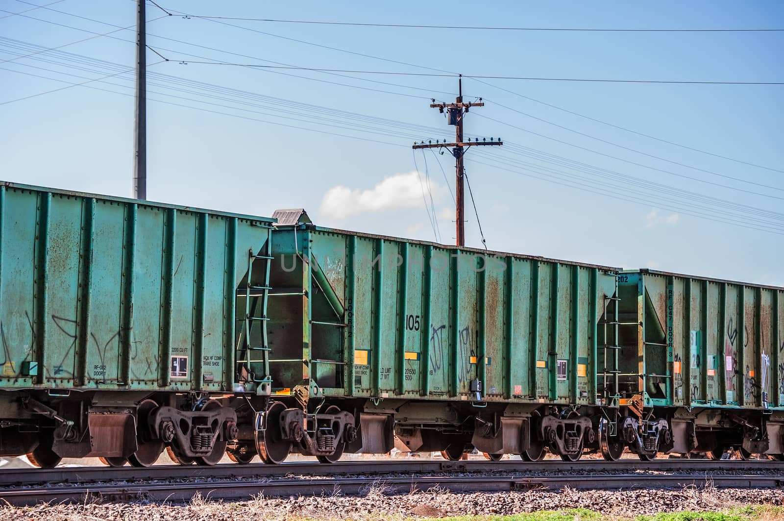 Railcars waiting on a siding for thier turn to be loaded.