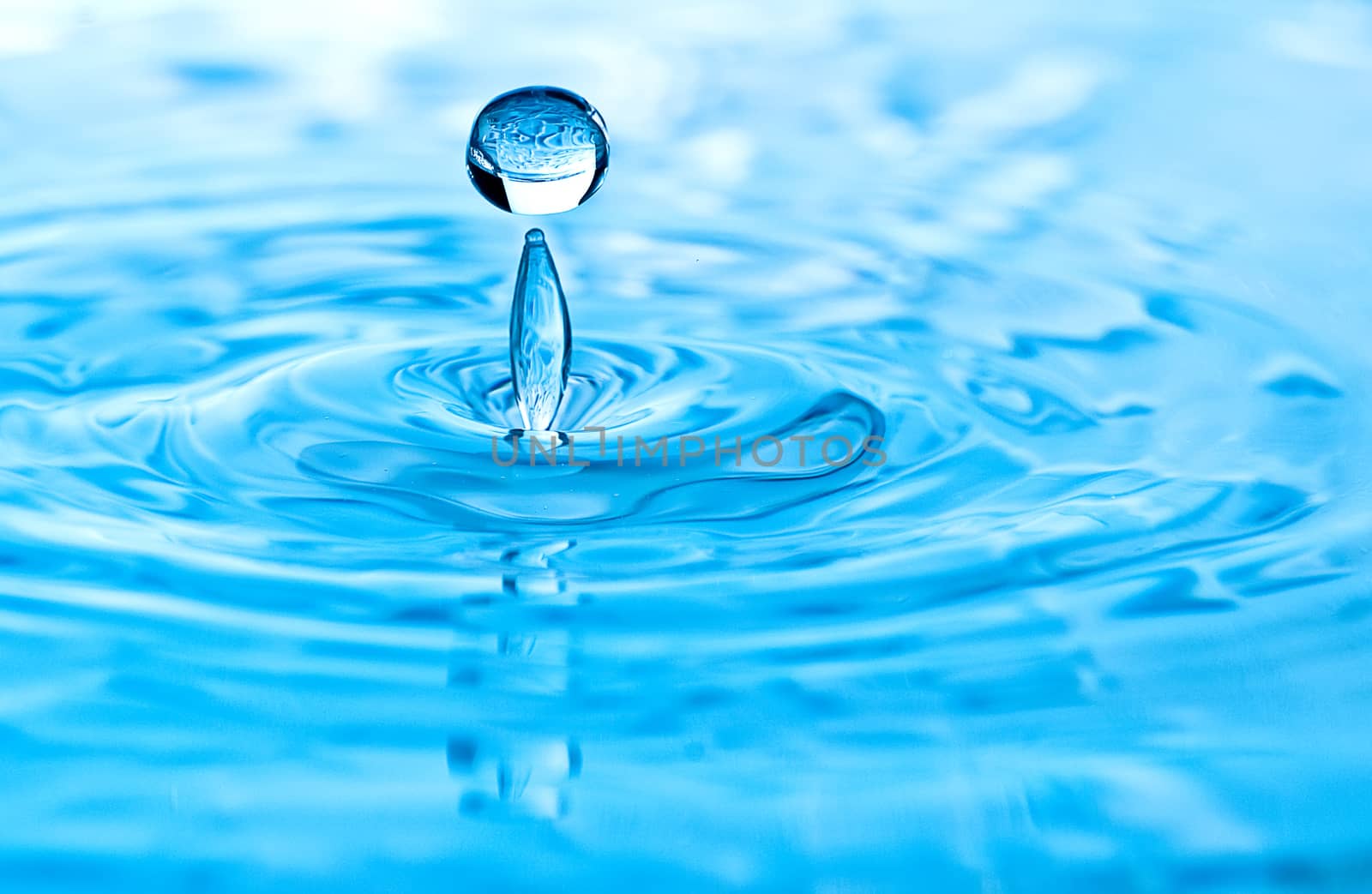 Stop action photo of water drop with reflection