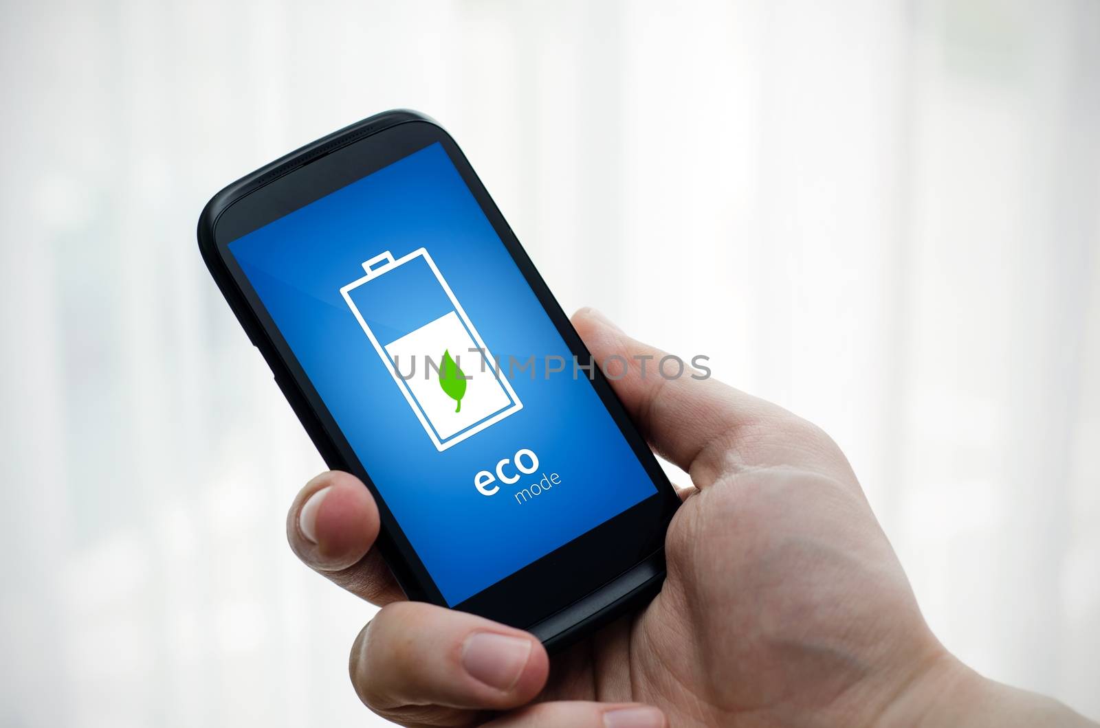 Man holding phone with eco battery mode on display by simpson33