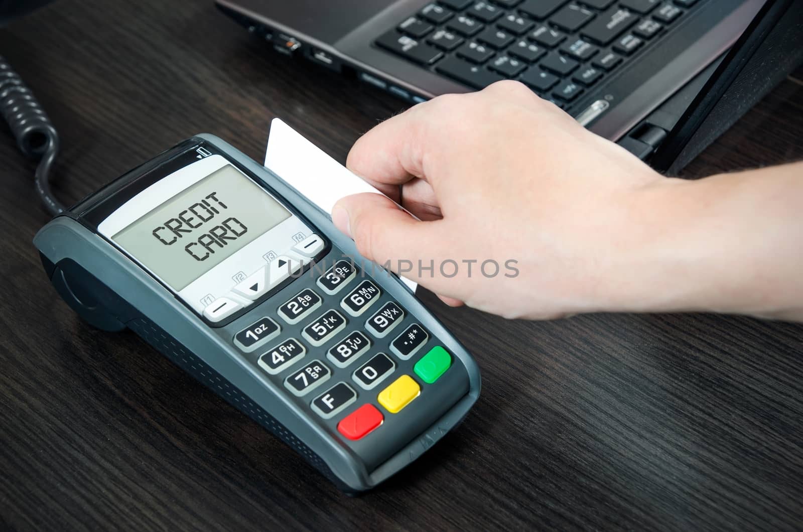 Man pays with credit card. Swiping plastic card through terminal by simpson33