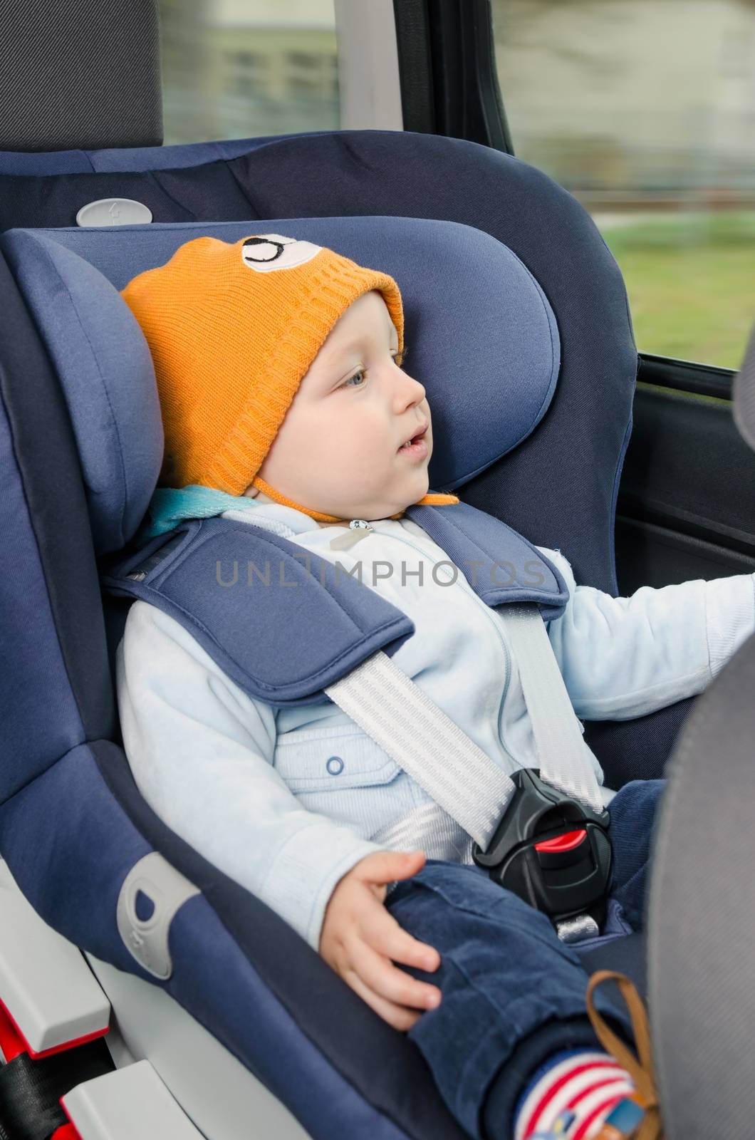 Cute boy sitting in the car seat 